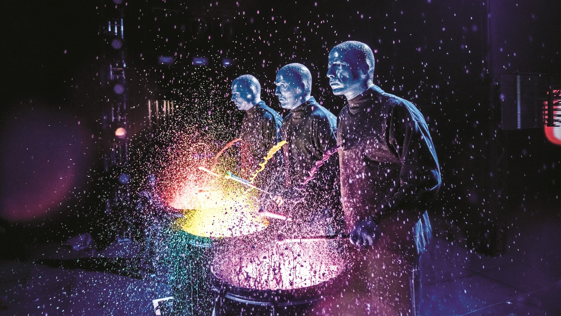 Blue Man Group performing with drums and paint HD Wallpaper