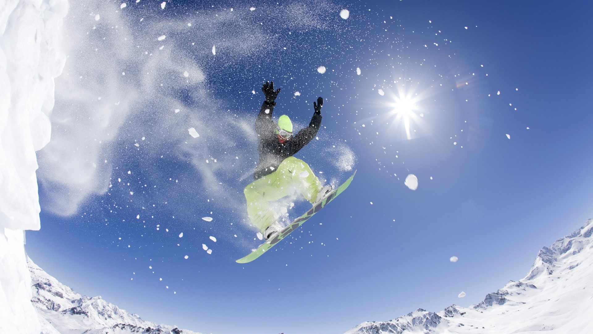 Snowboarder jumping in the air with snow spray HD Wallpaper
