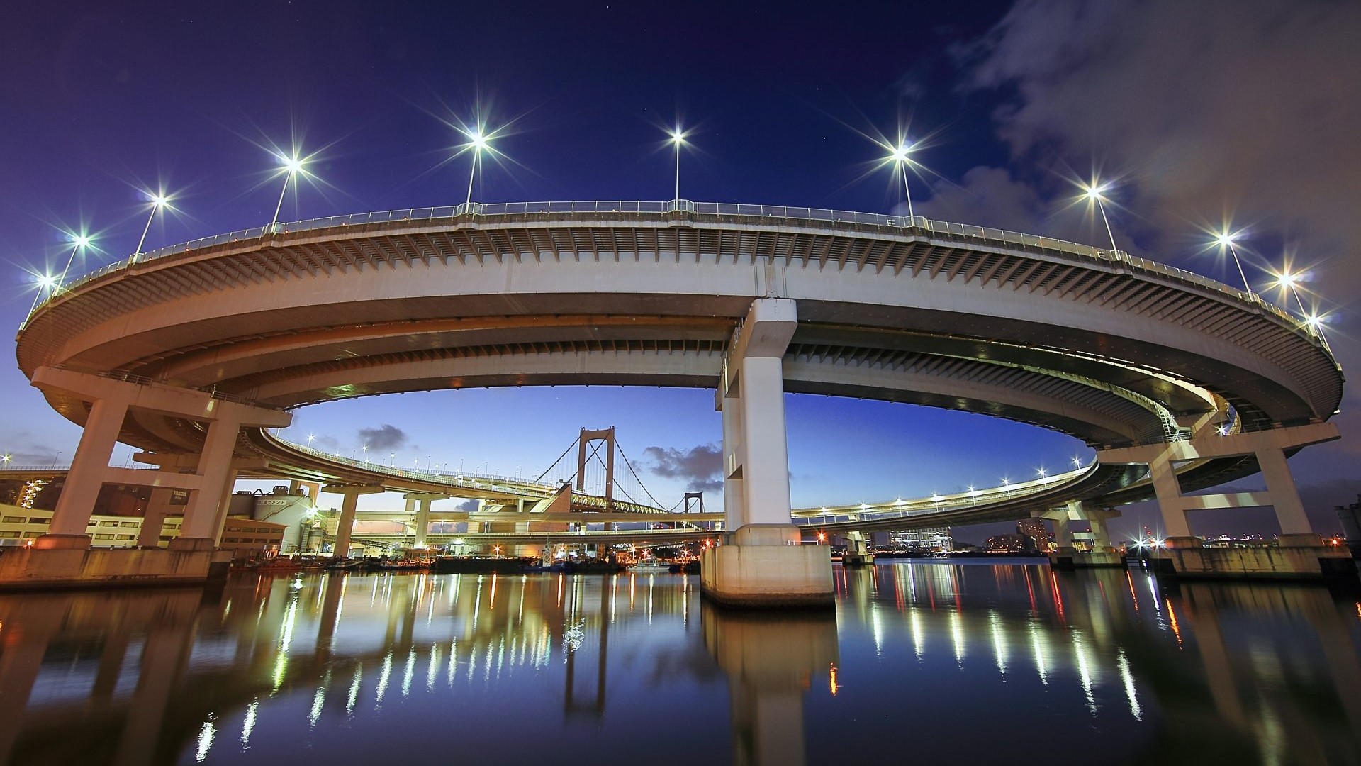 Rainbow Bridge illuminated at night over water in Tokyo HD Wallpaper