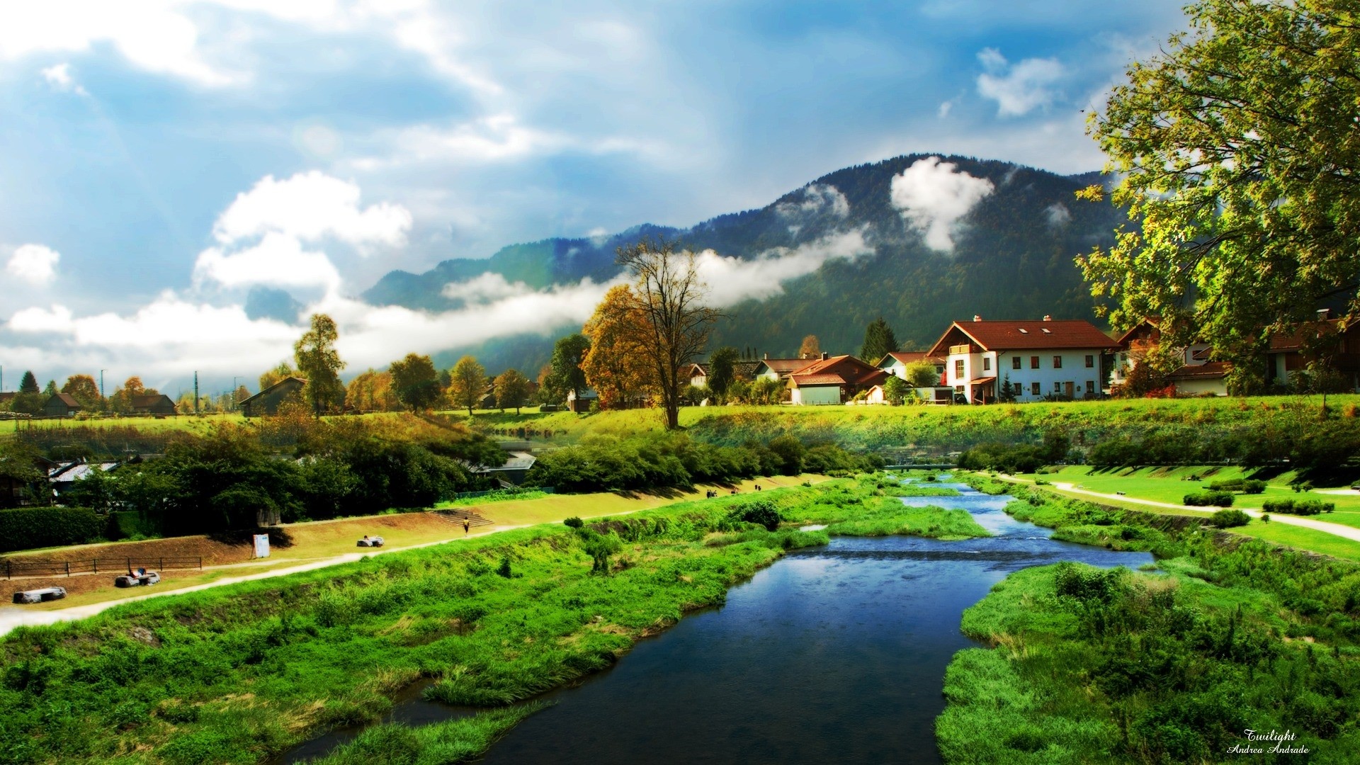 Village by a river with mountains and clouds HD Wallpaper
