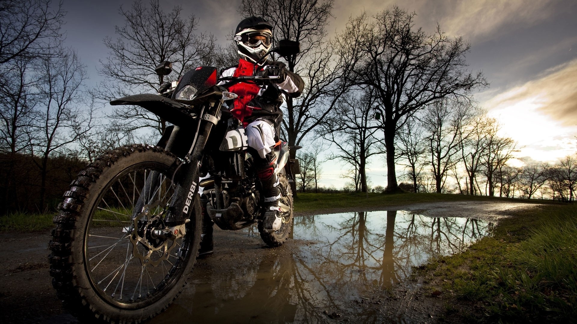 Motorcyclist on a Derbi motorcycle in a forest HD Wallpaper