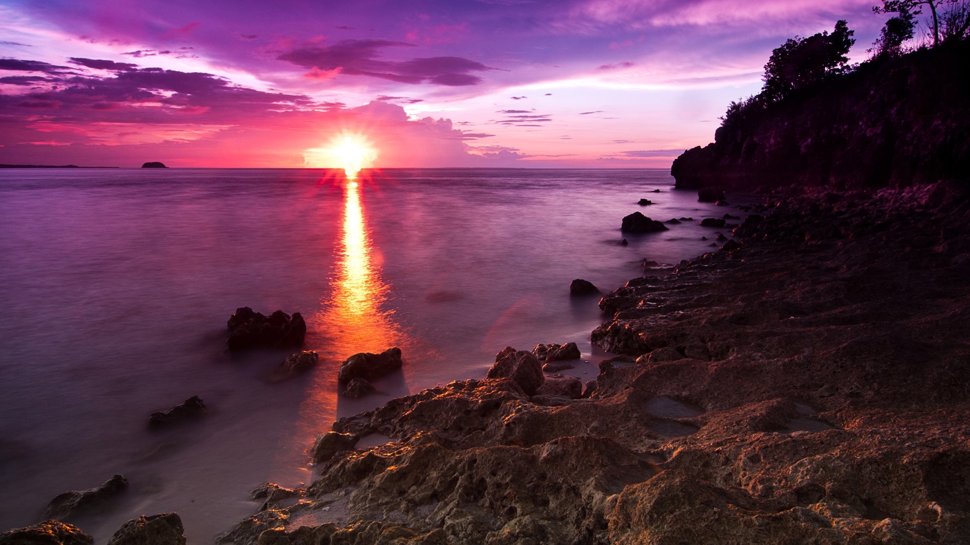 Sunset over the ocean with rocky shore HD Wallpaper