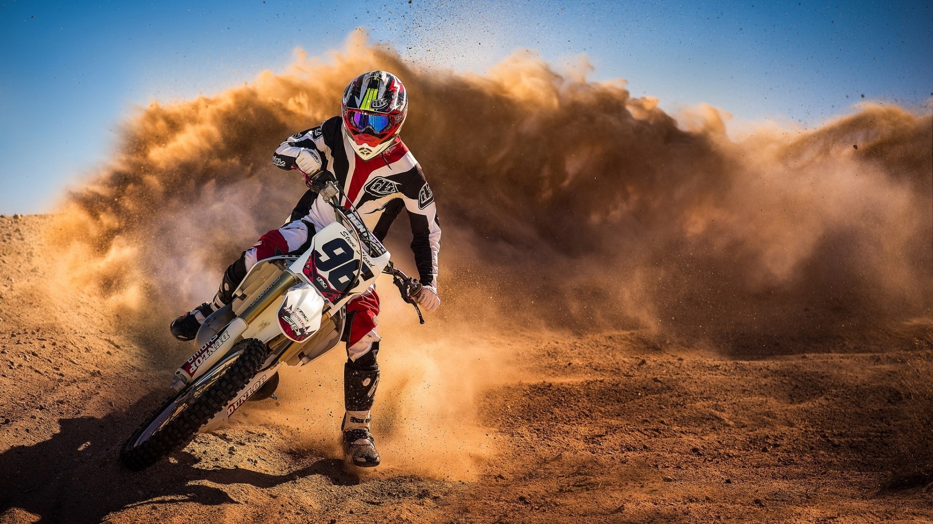 Motocross rider kicking up dust HD Wallpaper