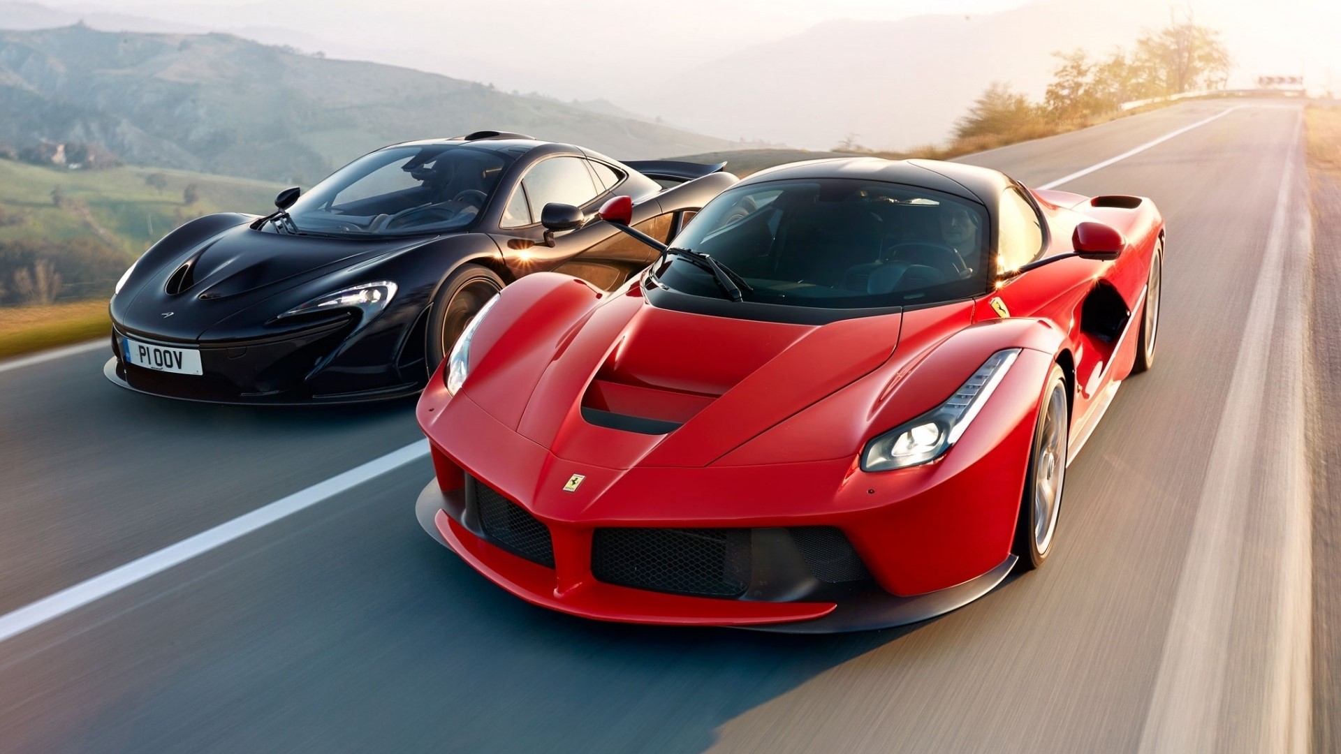 Red Ferrari and Black McLaren P1 on a Road HD Wallpaper