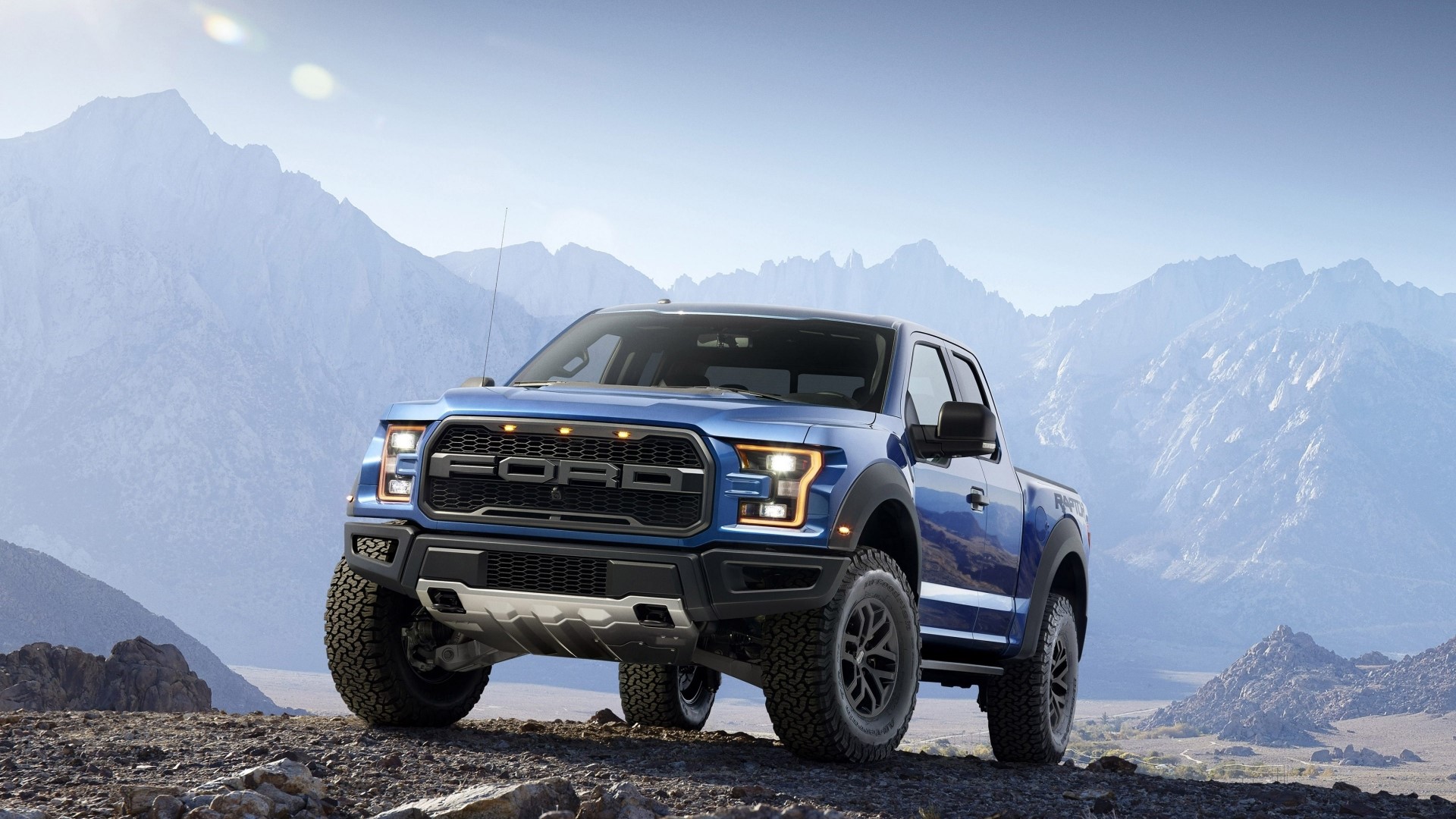 Blue Ford F-150 Raptor truck in mountains HD Wallpaper