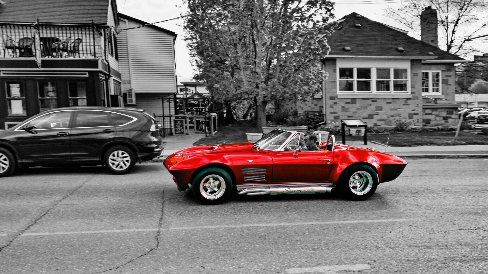 Red convertible classic car driving on a street HD Wallpaper