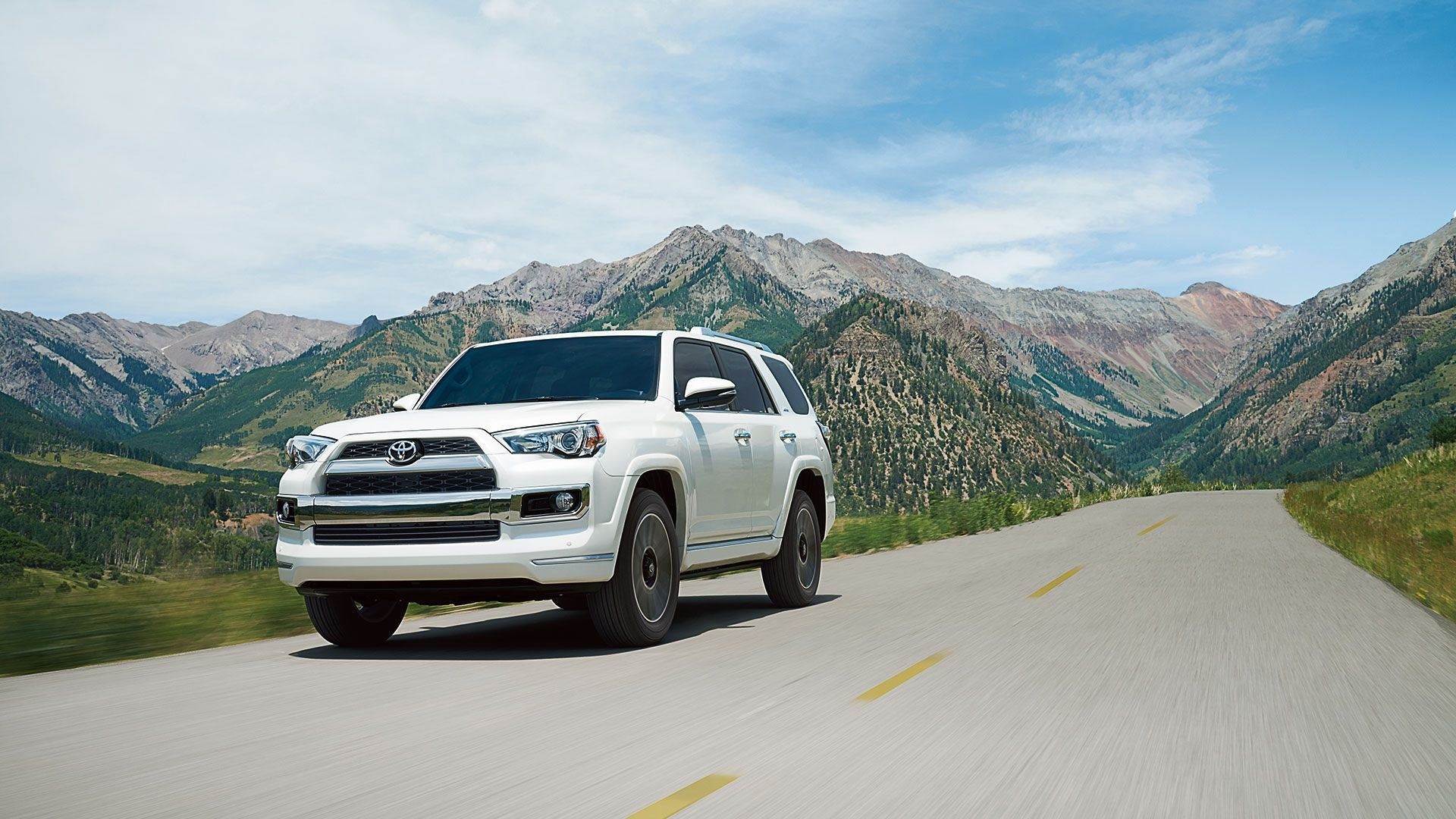 2014 Toyota 4Runner driving on a mountain road HD Wallpaper