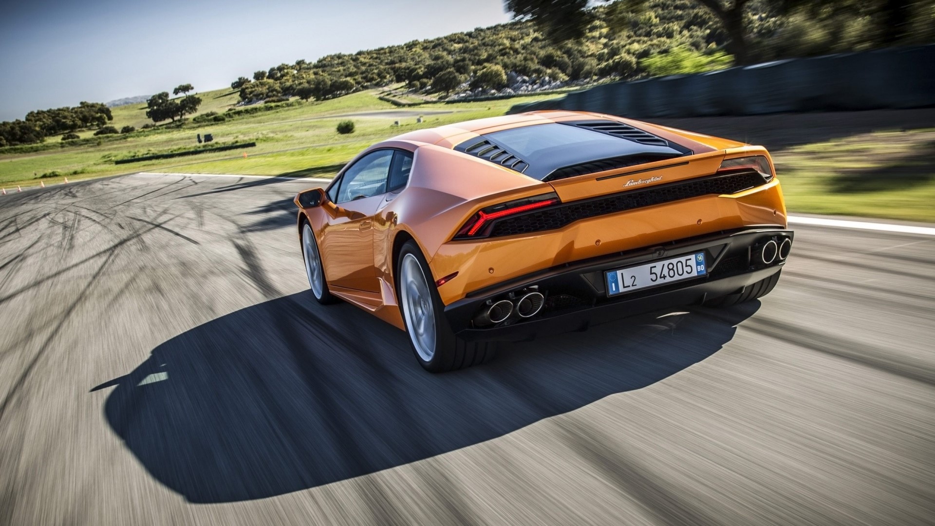 Orange Lamborghini Huracan on a Racetrack HD Wallpaper