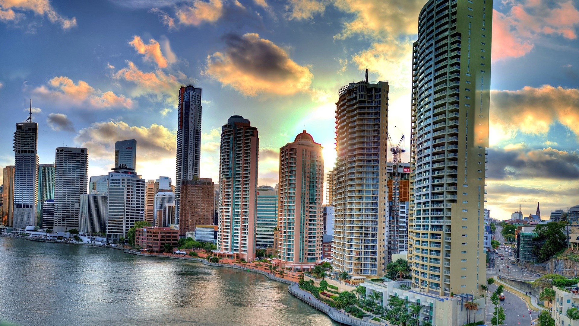 Cityscape with skyscrapers and river at sunset HD Wallpaper