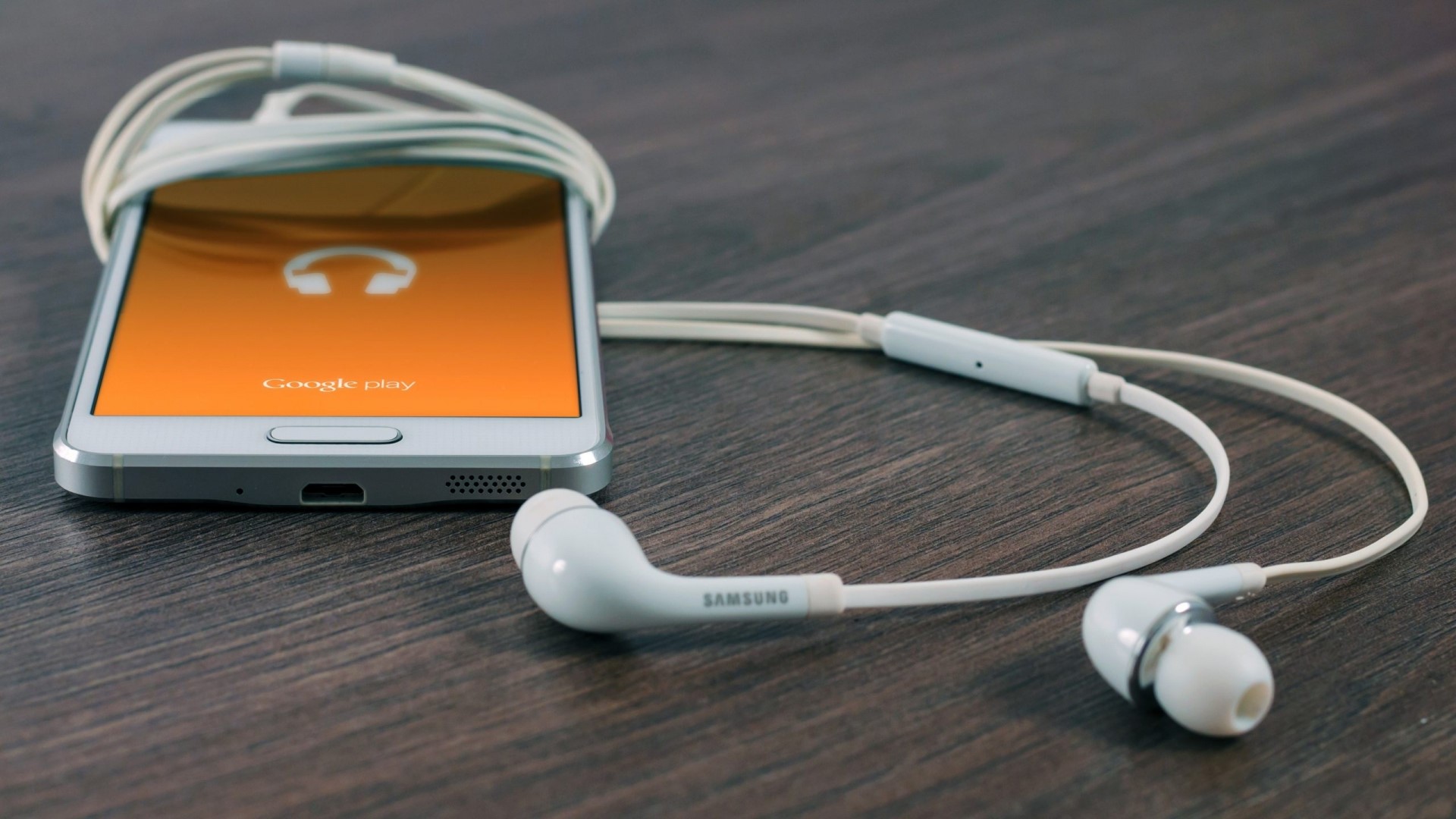 Samsung S6 smartphone with Google Play and earphones HD Wallpaper