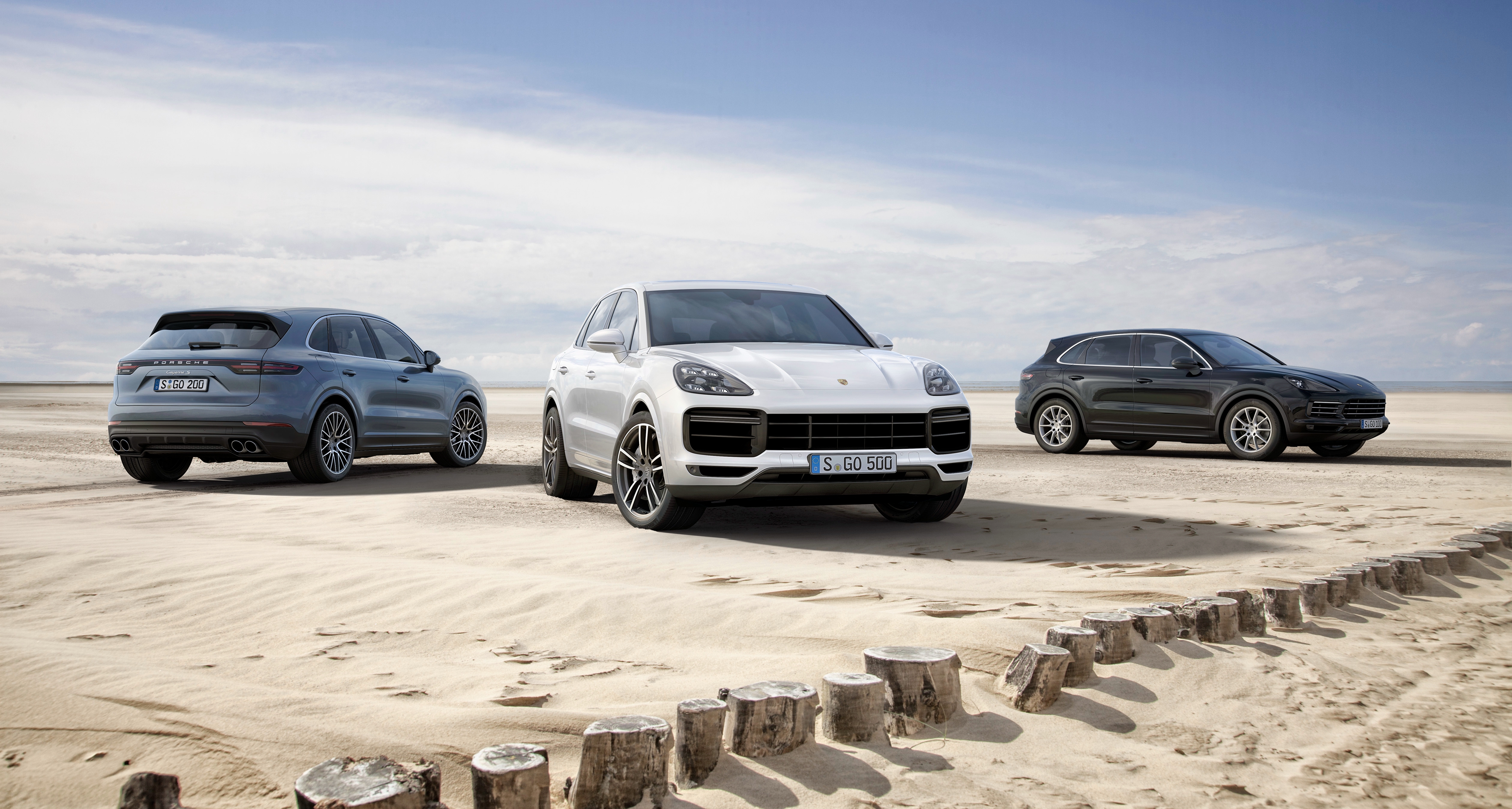 Three Porsche Cayenne S SUVs on a beach HD Wallpaper