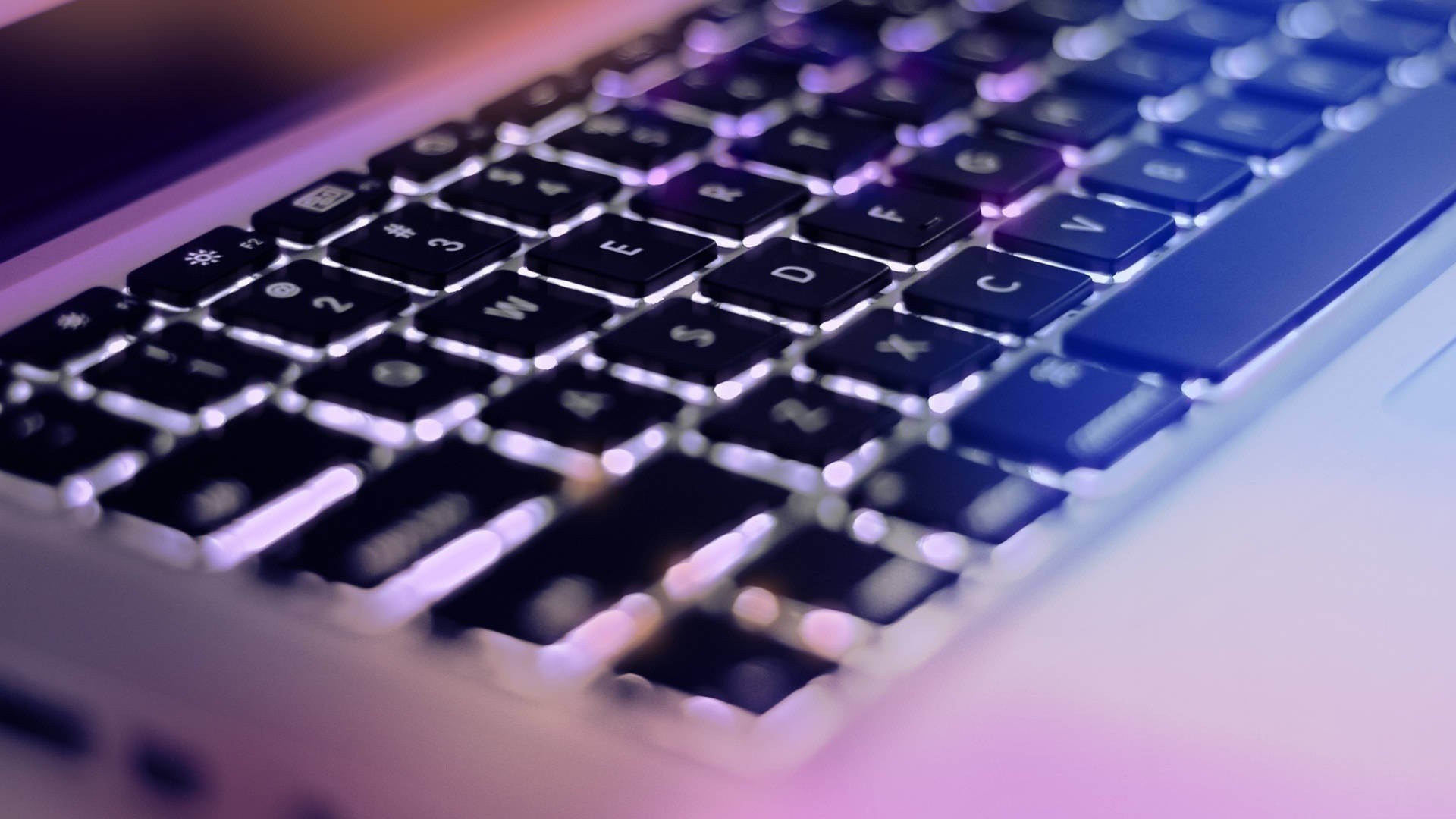 Close-up of a backlit laptop keyboard HD Wallpaper