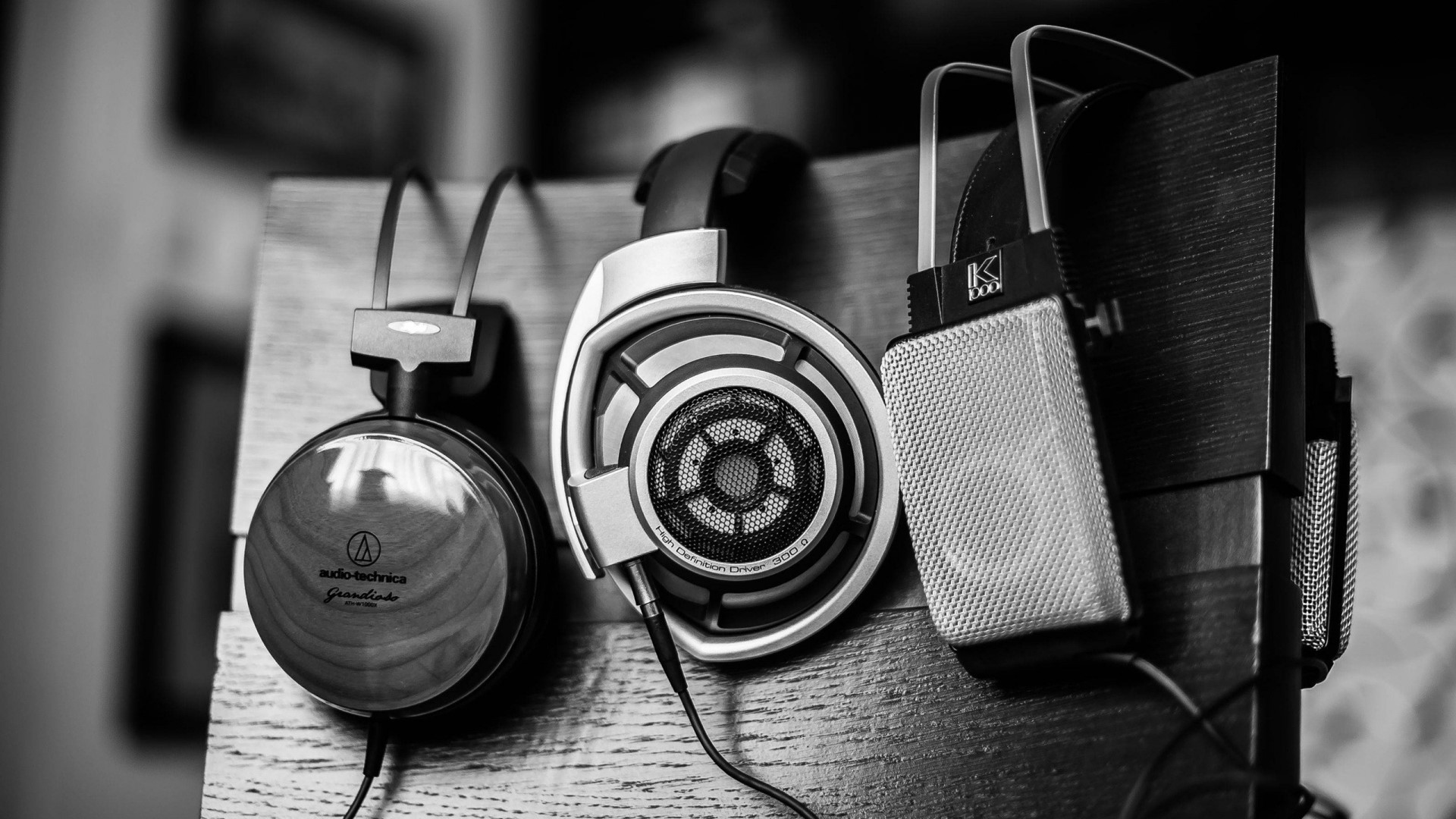 Three headphones on a wooden stand HD Wallpaper