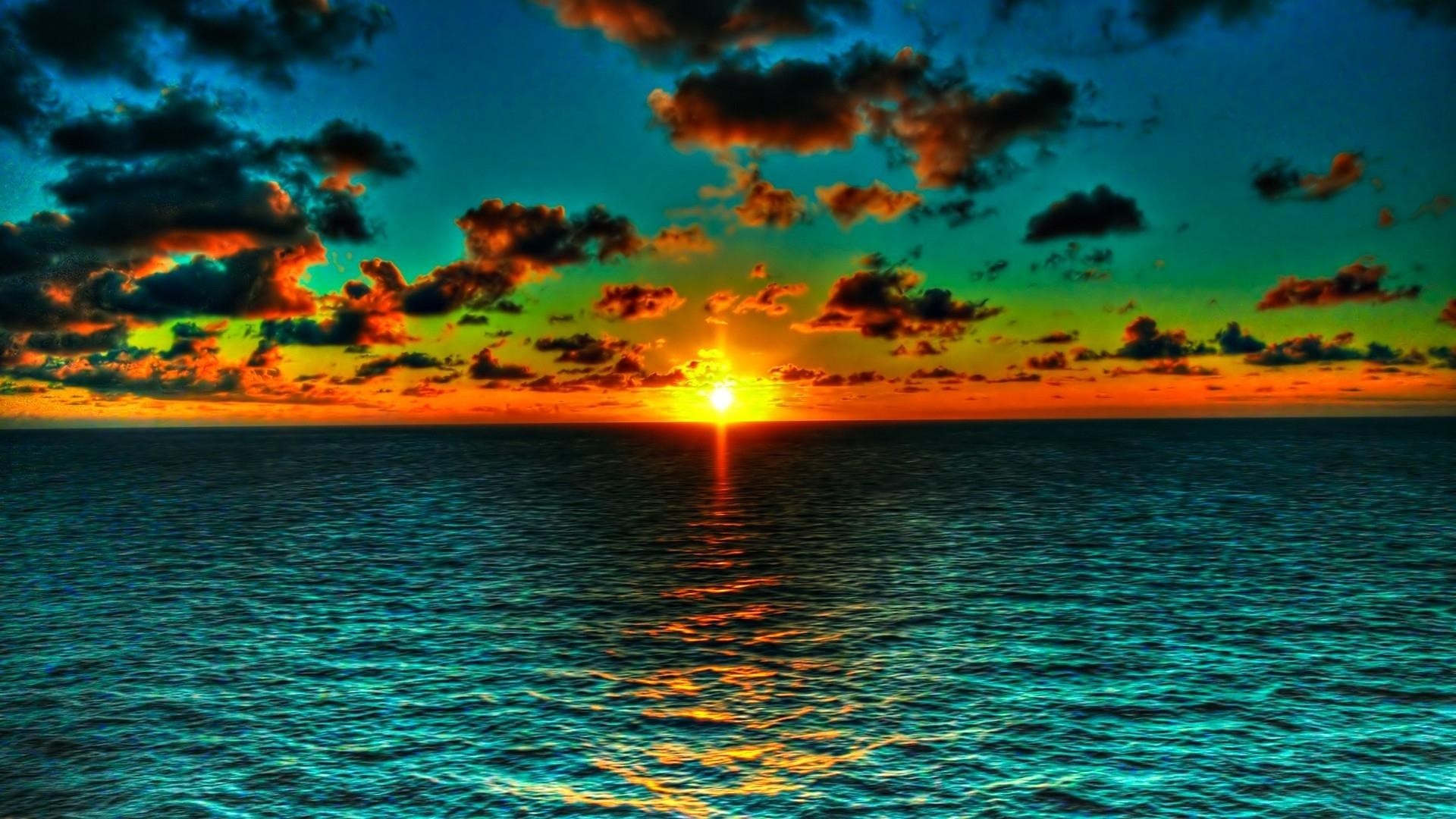 Sunset over the ocean with colorful clouds HD Wallpaper