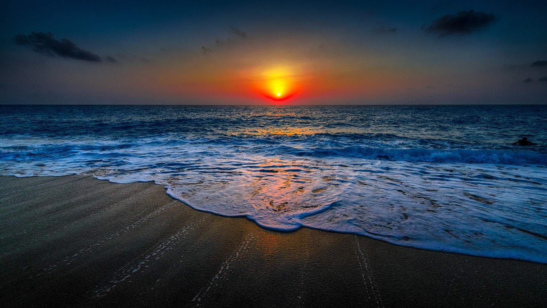Sunset over the ocean with waves on the beach HD Wallpaper