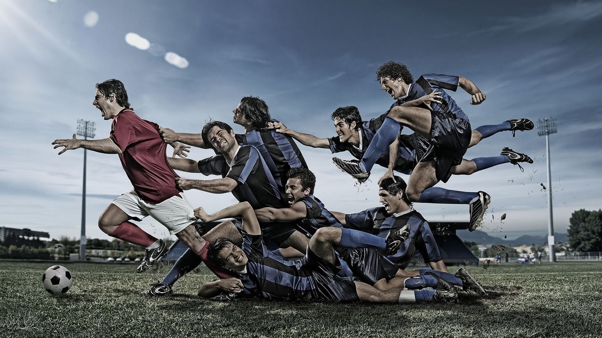 Soccer players in action on a field HD Wallpaper