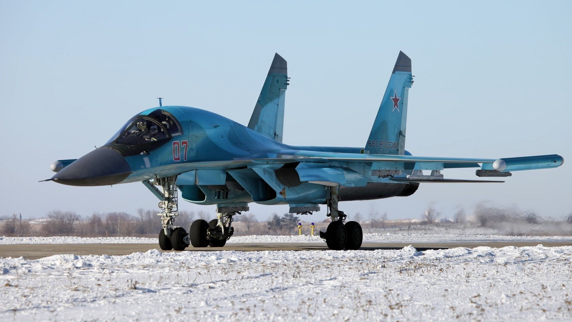 Sukhoi Su-34 fighter jet on snowy tarmac HD Wallpaper