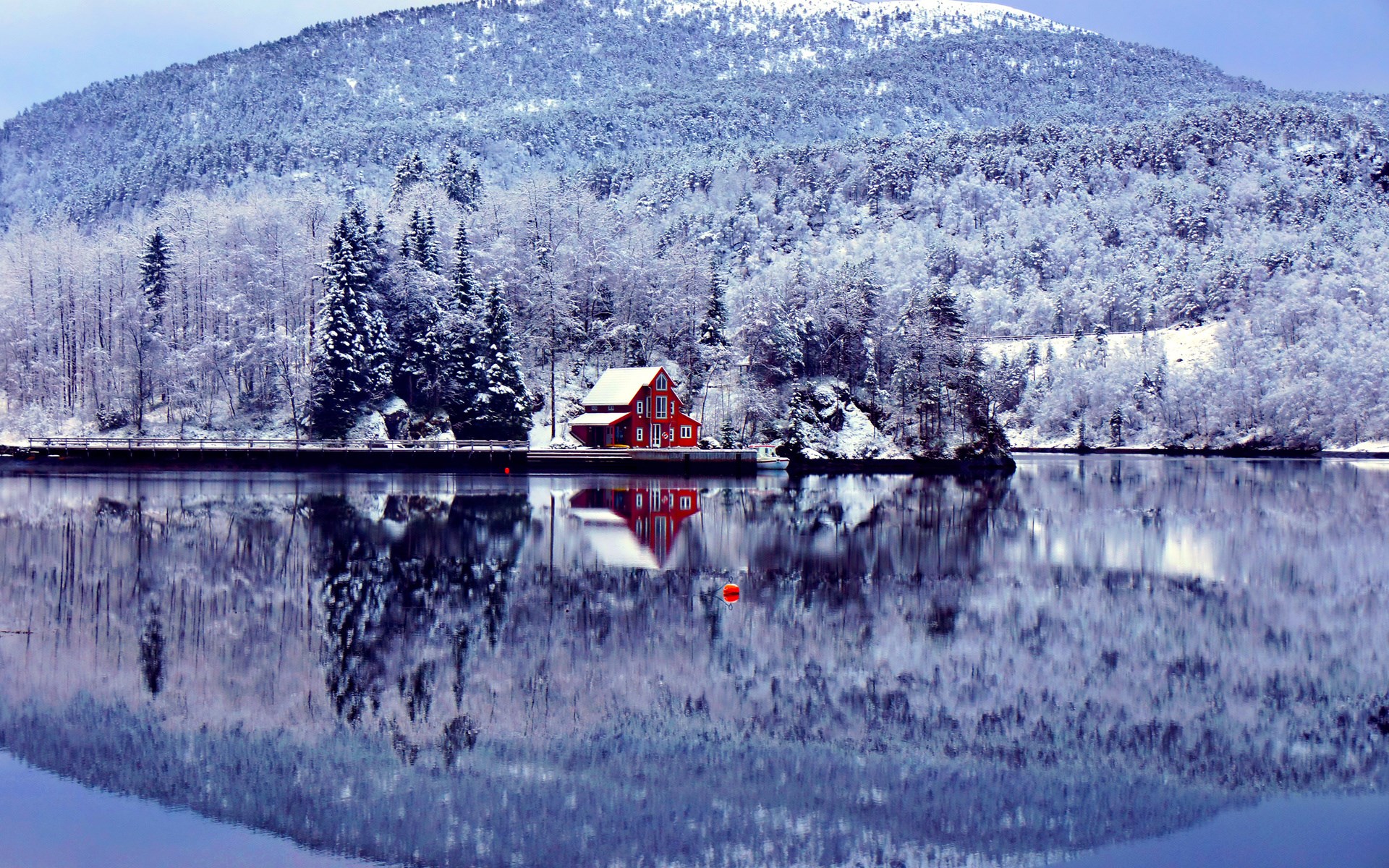Red house on a snowy lake with mountain backdrop HD Wallpaper