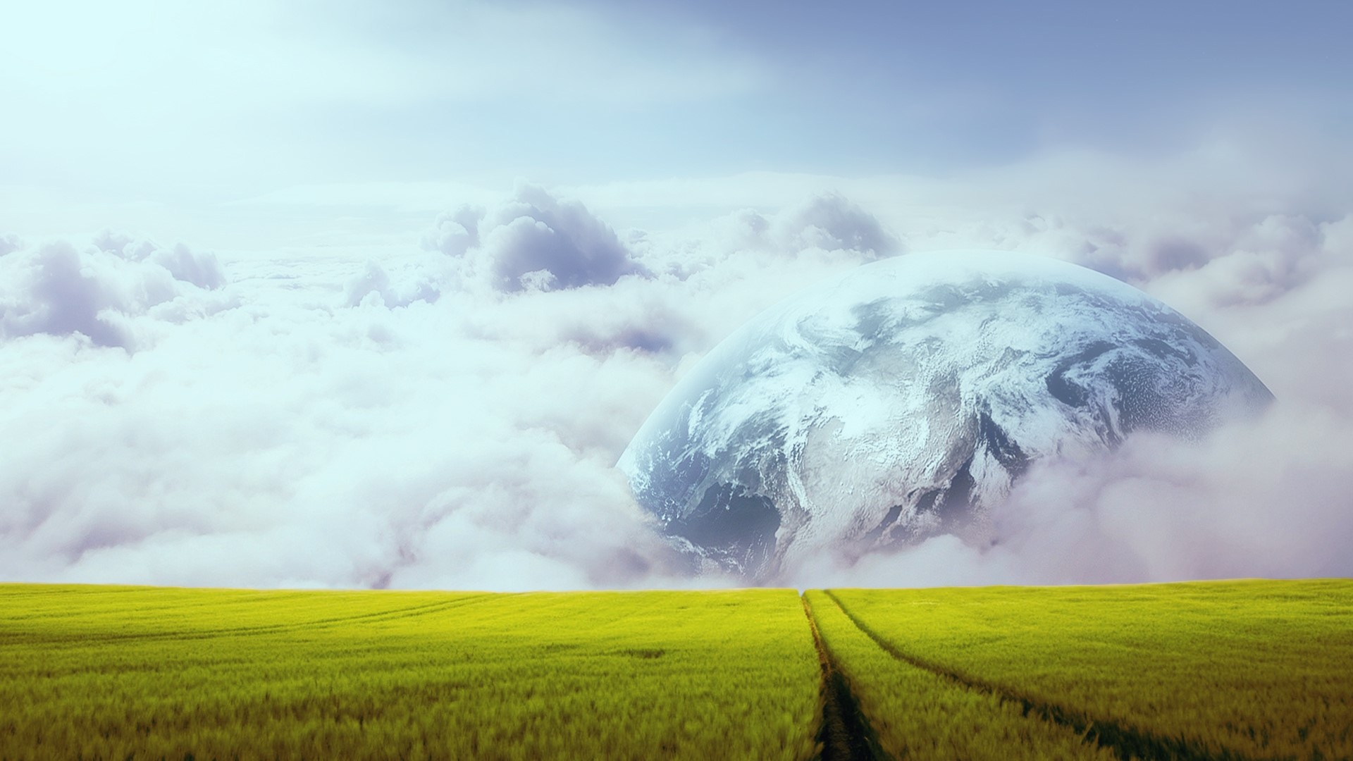 Planet Earth emerging from clouds over a green field HD Wallpaper