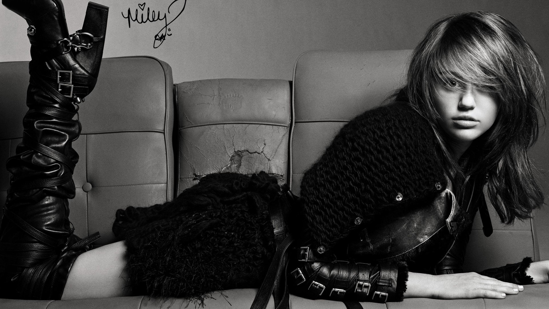 Miley Cyrus on a couch HD Wallpaper