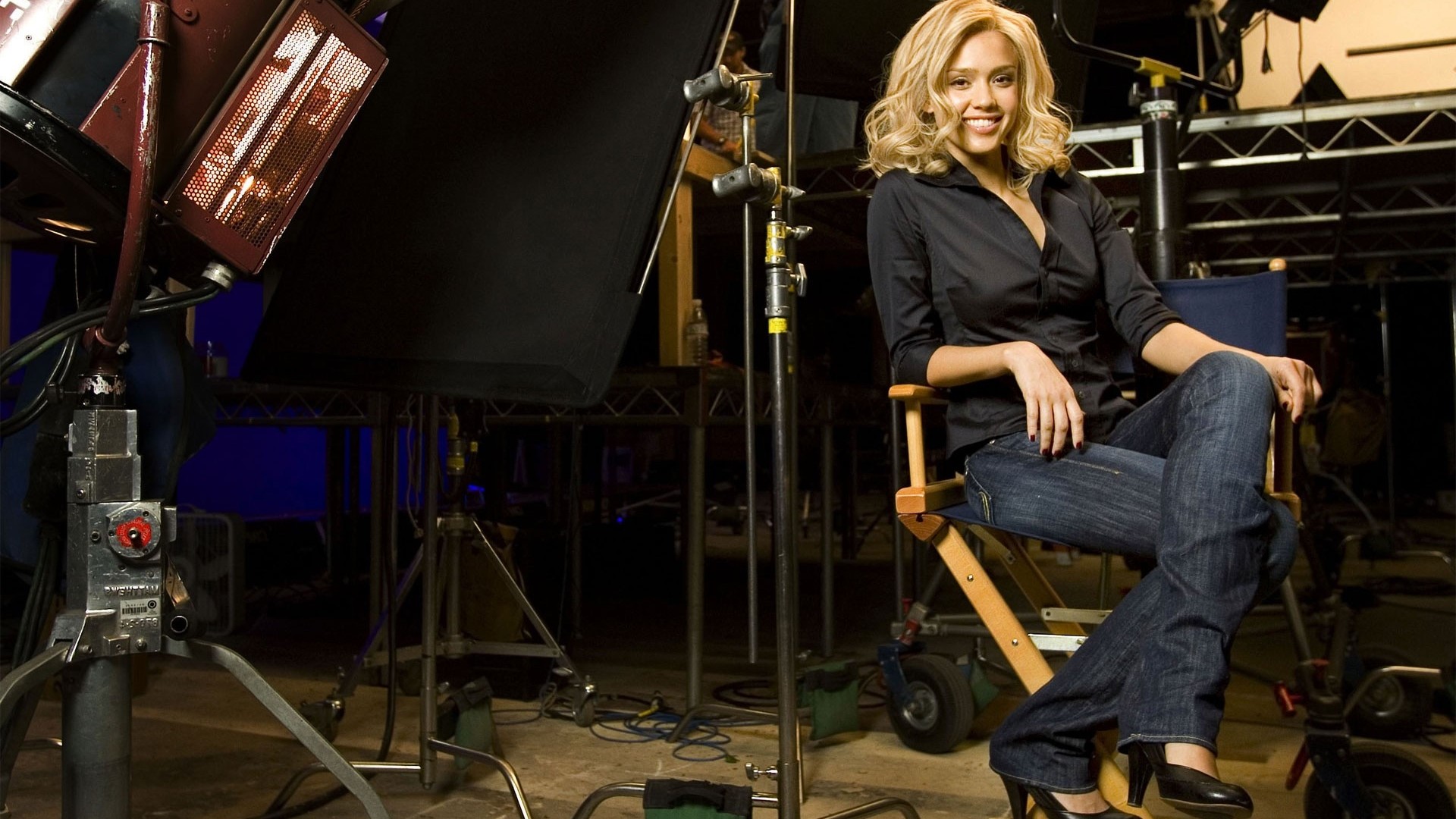 Jessica Alba sitting on a director's chair on a film set HD Wallpaper