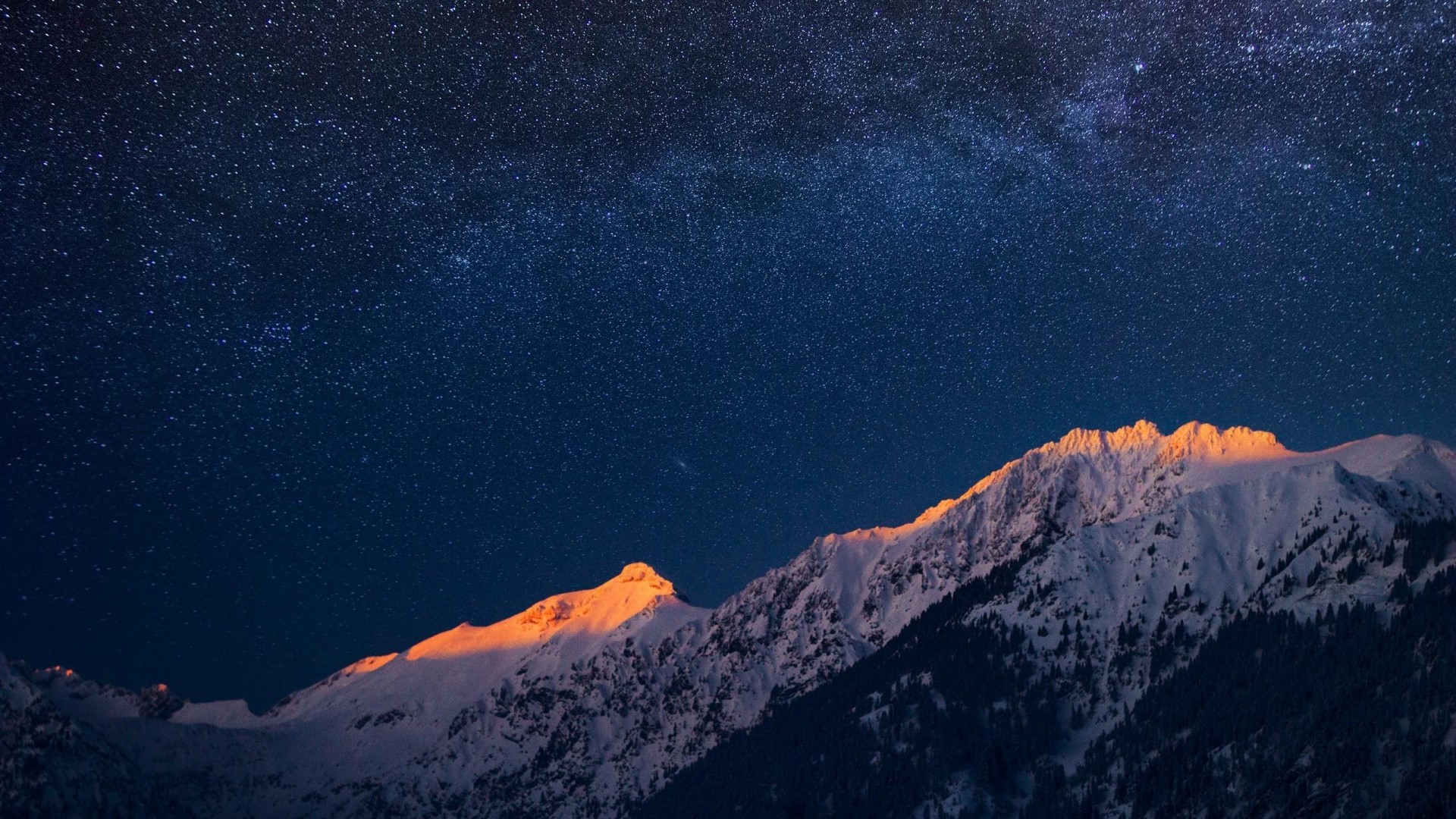 Snowy mountains under a starry night sky HD Wallpaper