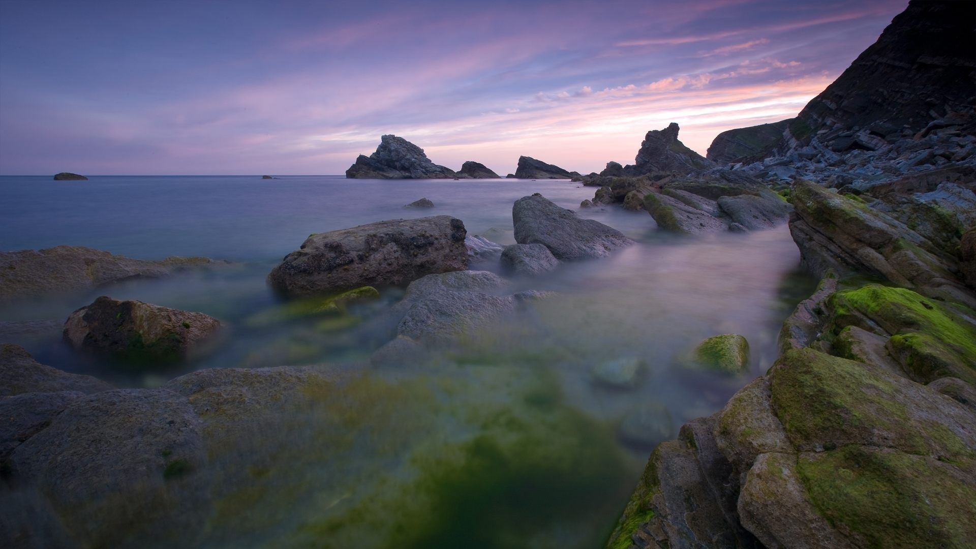 Rocky coastline with purple sky and ocean HD Wallpaper