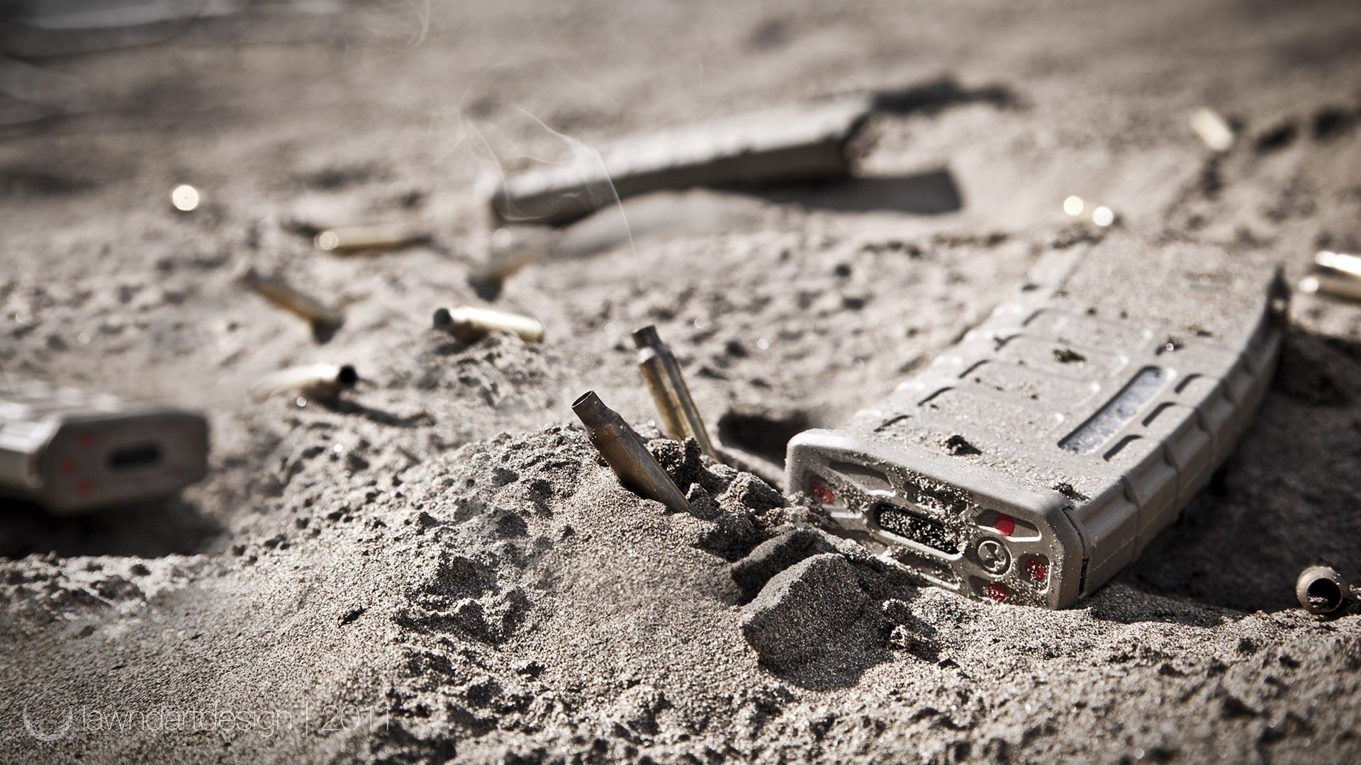 Military rifle magazines and casings in sand HD Wallpaper