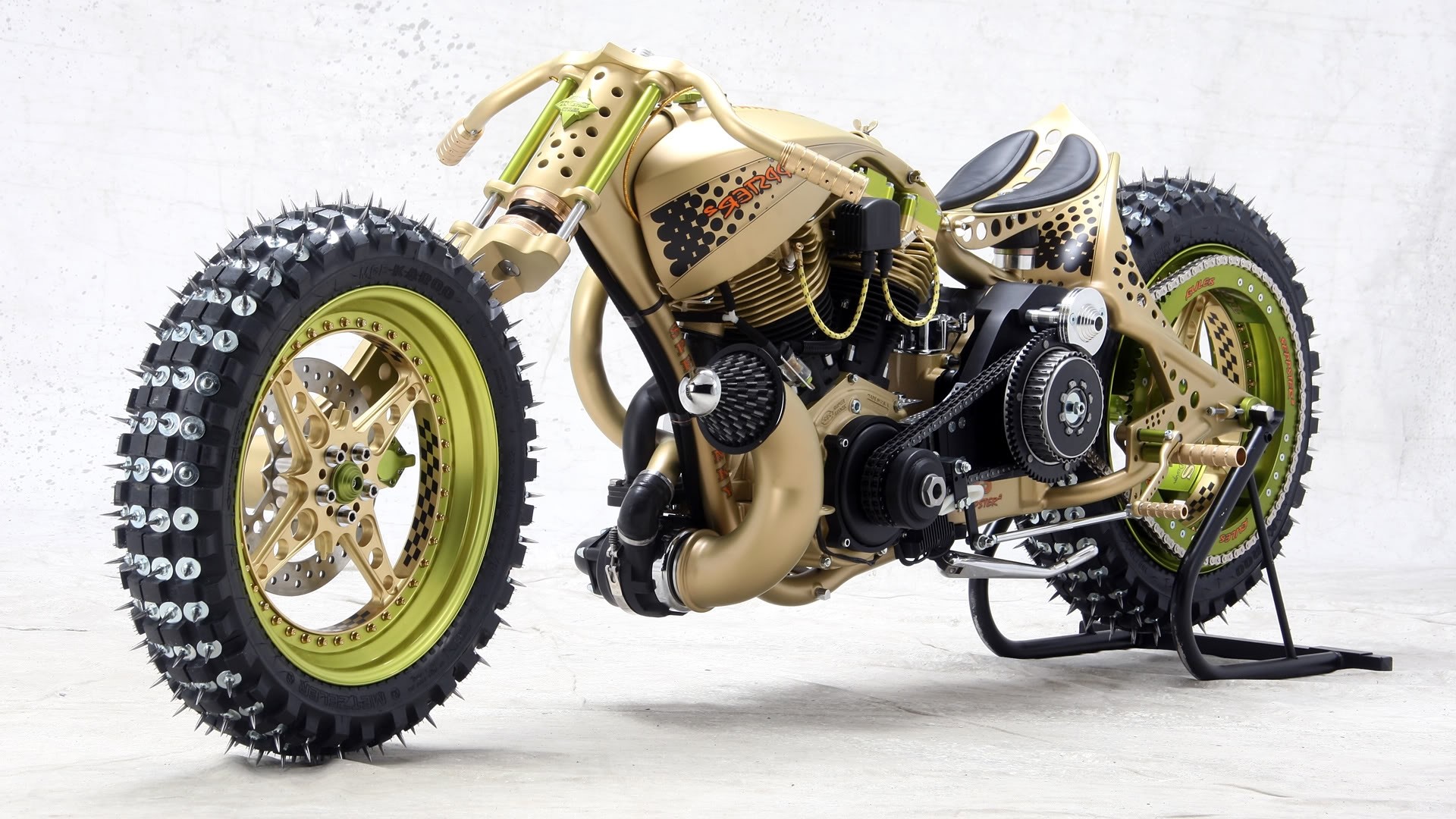 Custom gold motorcycle with spiked tires HD Wallpaper