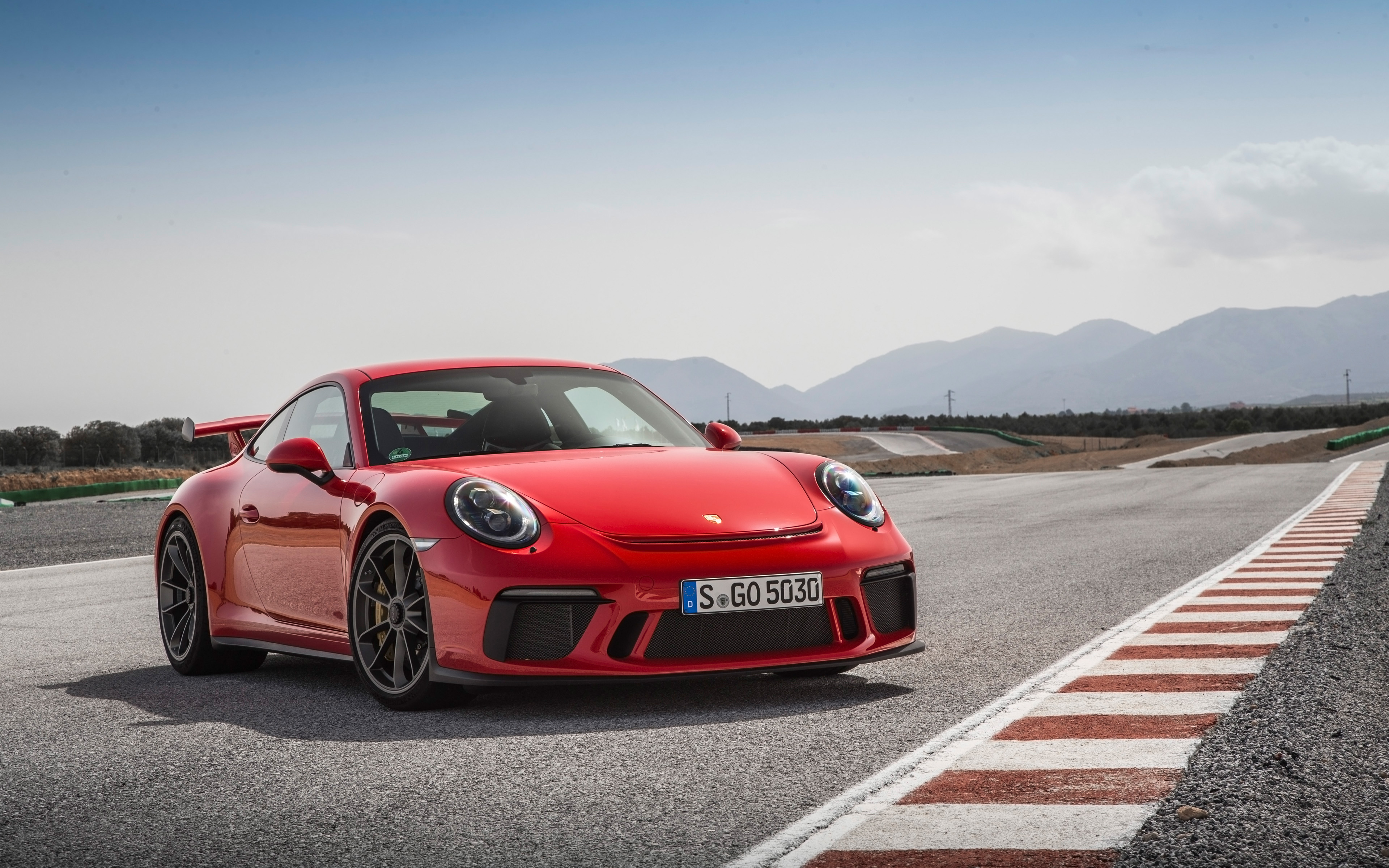 Guards Red Porsche 911 GT3 on a Racetrack HD Wallpaper
