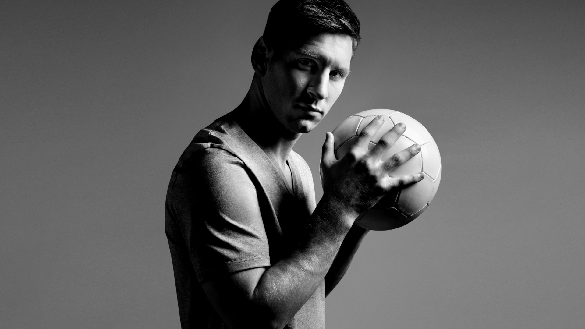 Lionel Messi holding a soccer ball HD Wallpaper