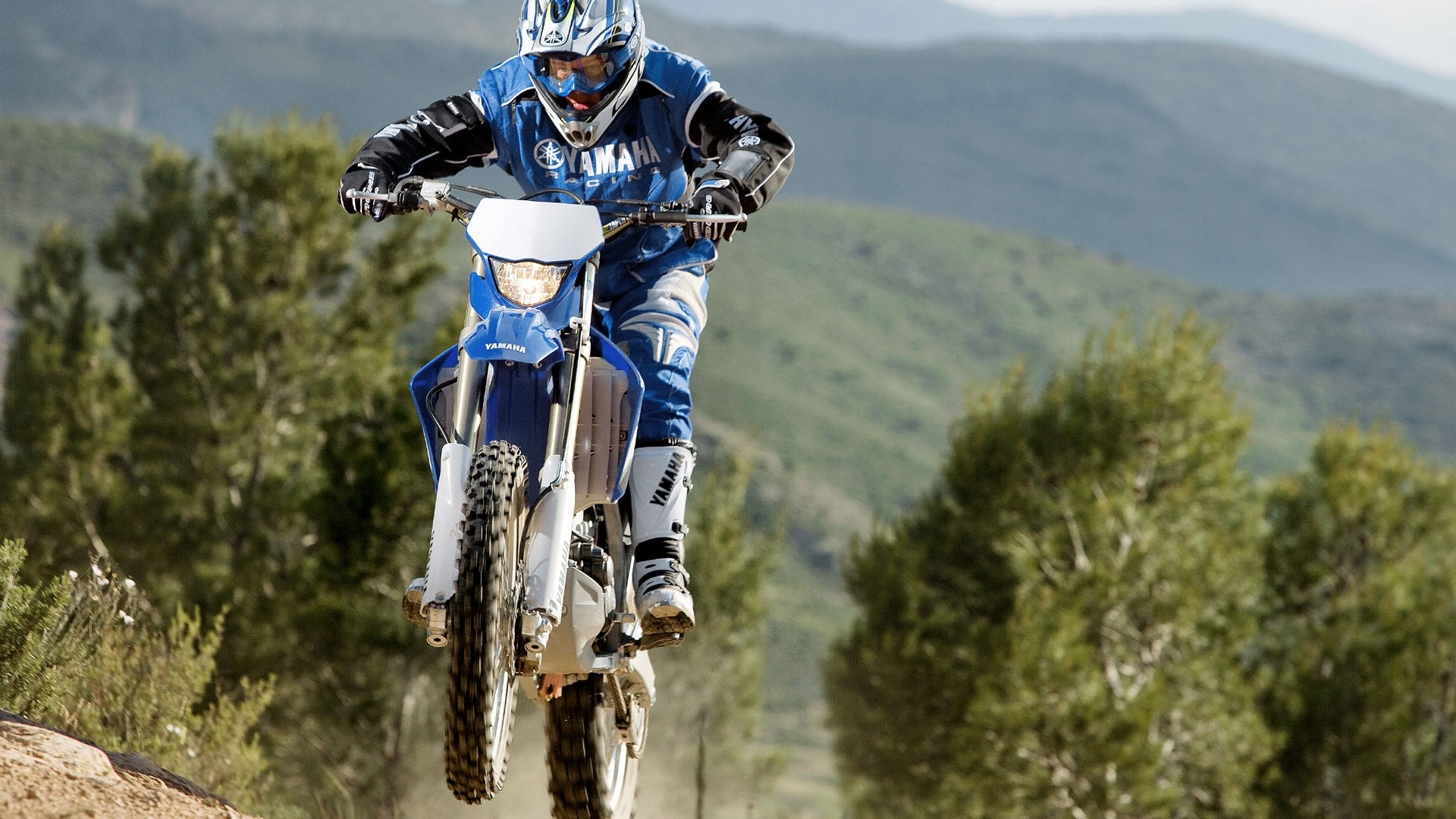 Yamaha dirt bike rider in blue gear on a trail HD Wallpaper