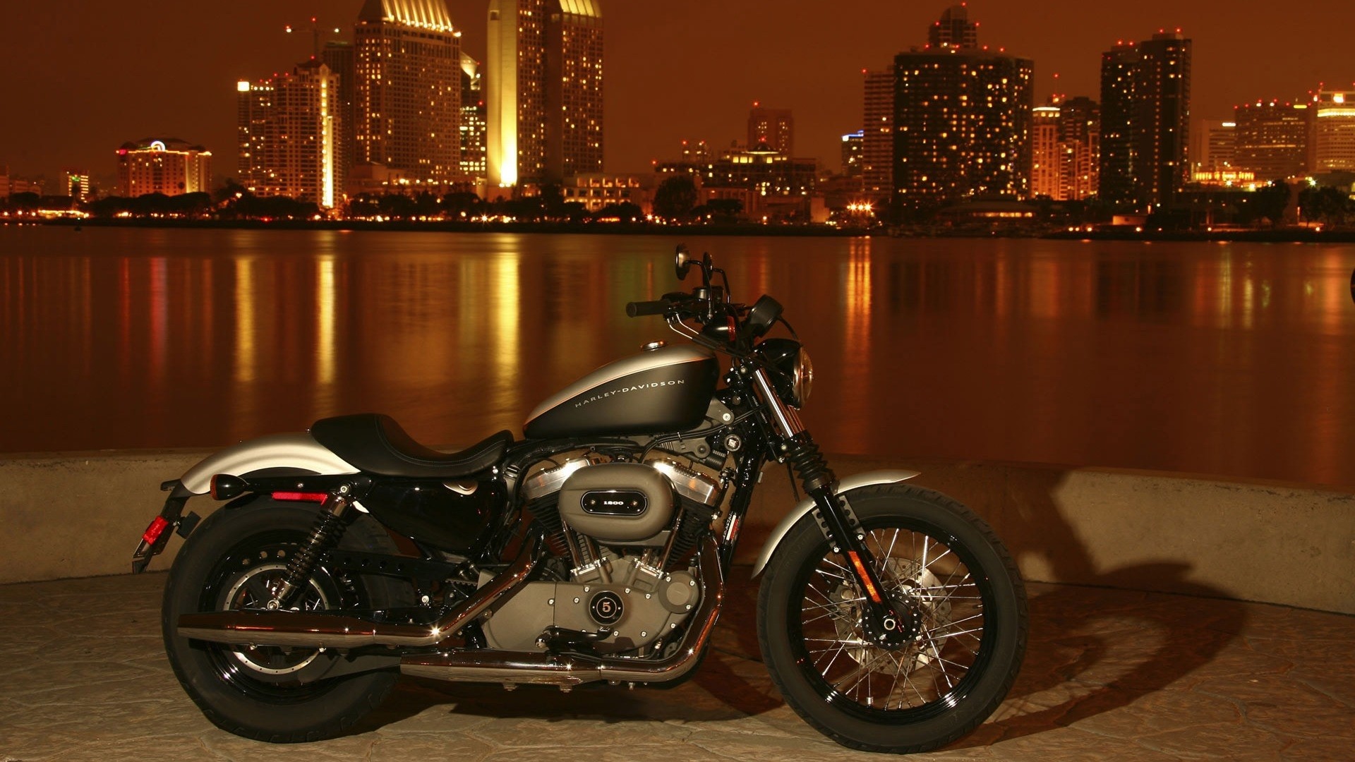 Harley-Davidson motorcycle in front of San Diego skyline at night HD Wallpaper