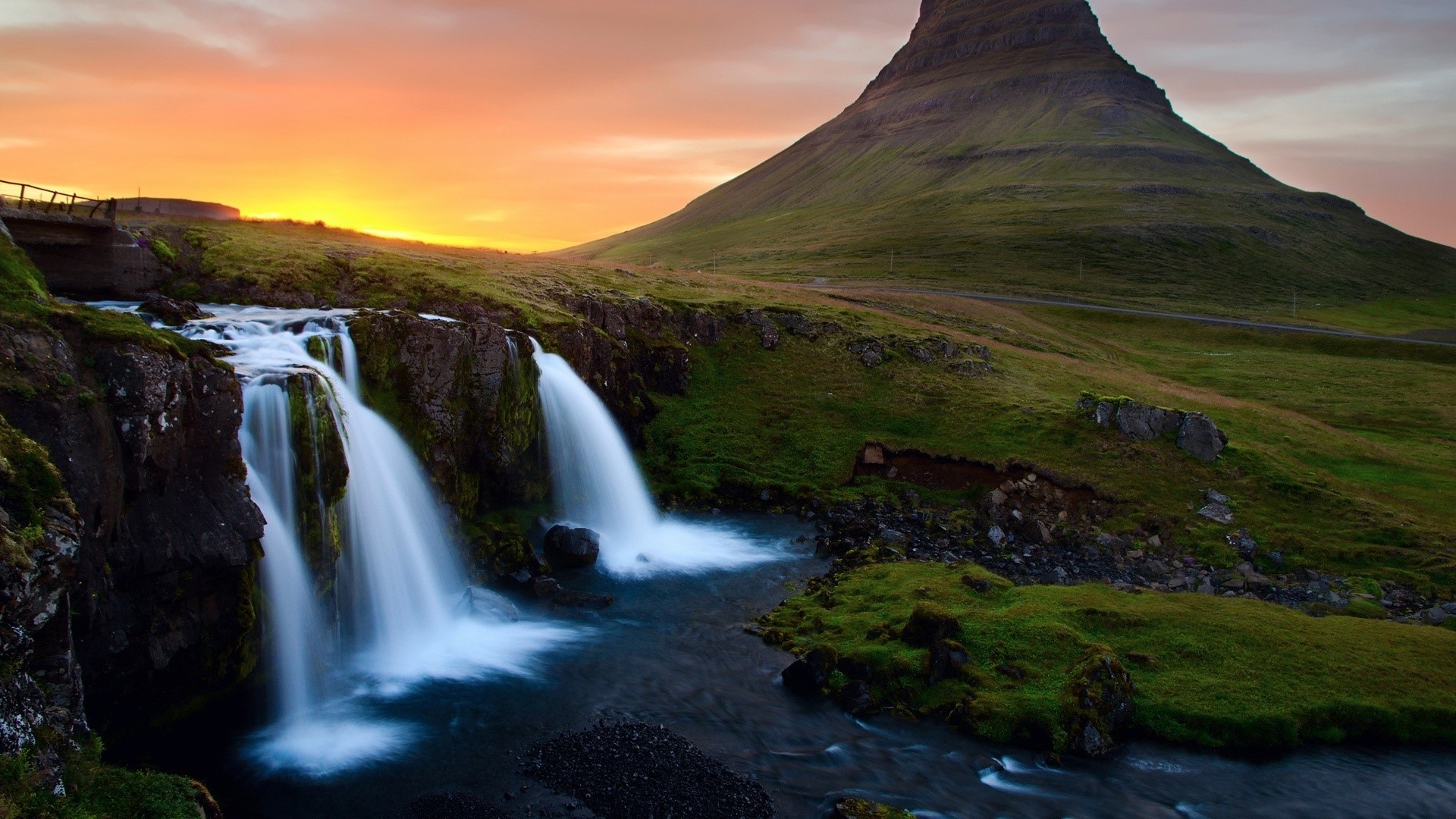 Waterfall near a mountain at sunset HD Wallpaper