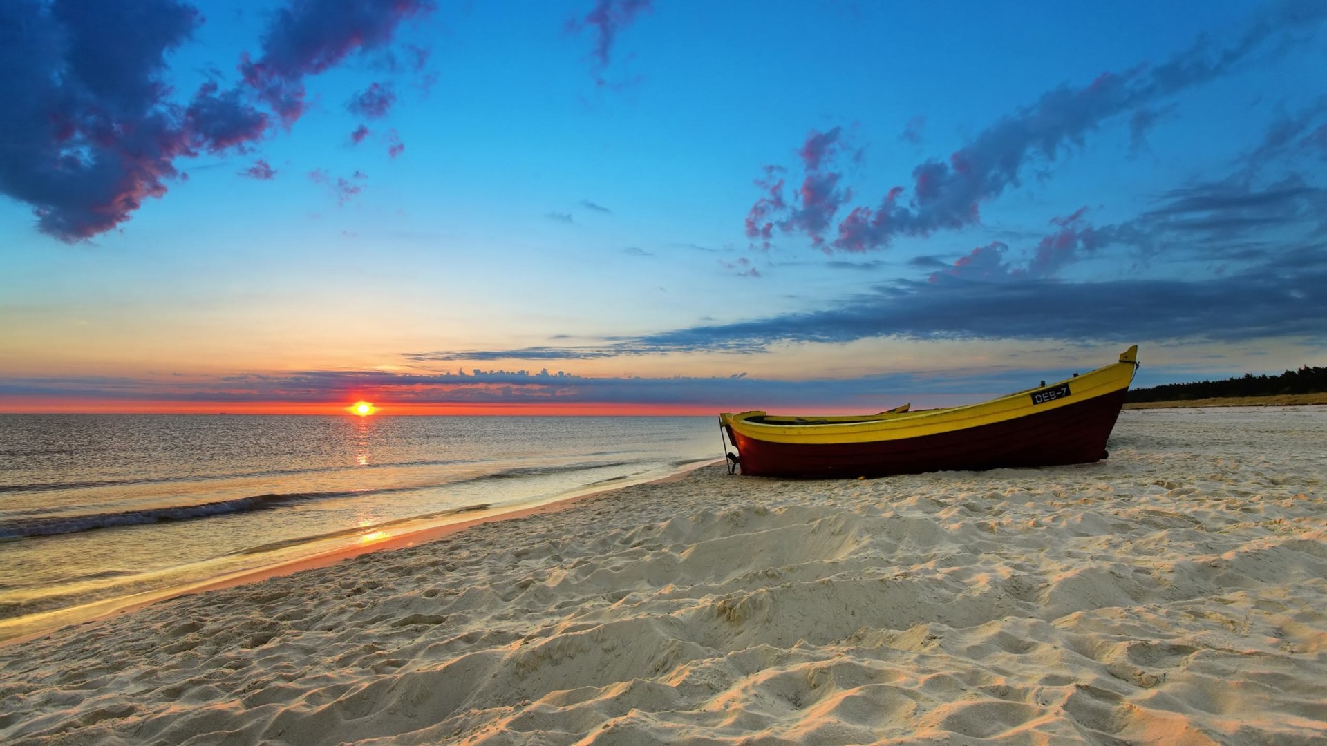 Boat on a sandy beach at sunset HD Wallpaper
