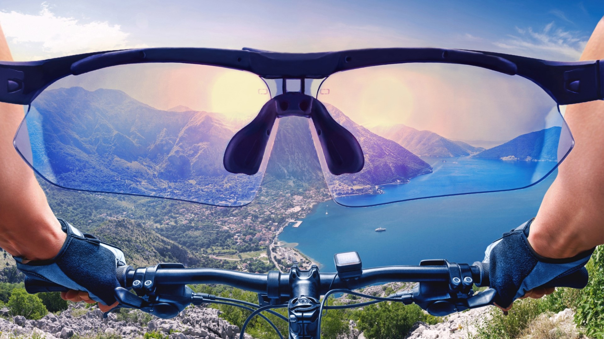 Person riding a bicycle with sunglasses showing mountain view HD Wallpaper