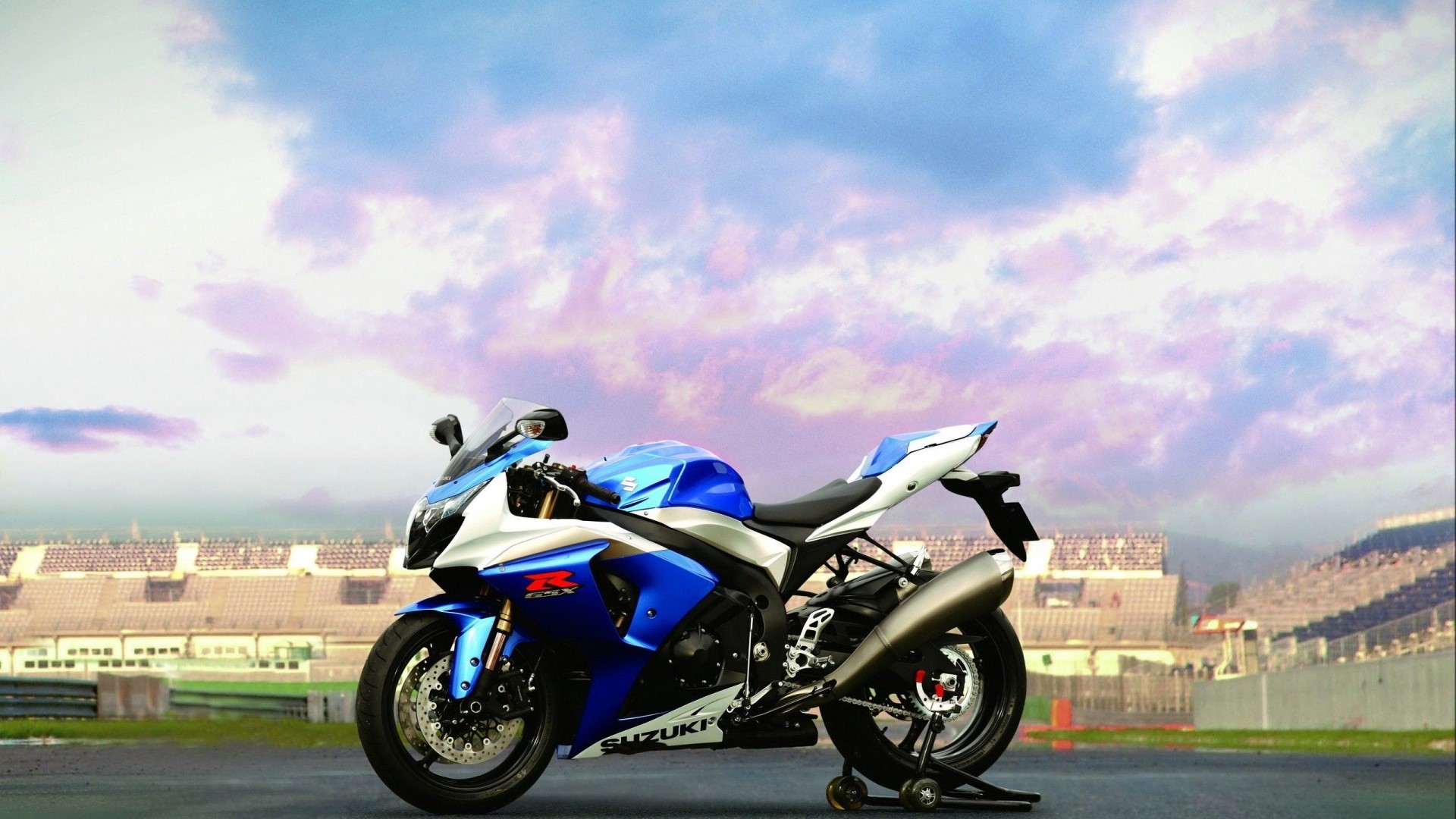 Blue and white Suzuki GSX-R1000 motorcycle on a racetrack HD Wallpaper