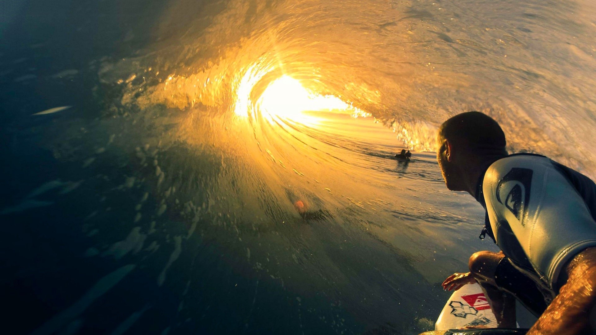 Surfer inside a large wave at sunset HD Wallpaper