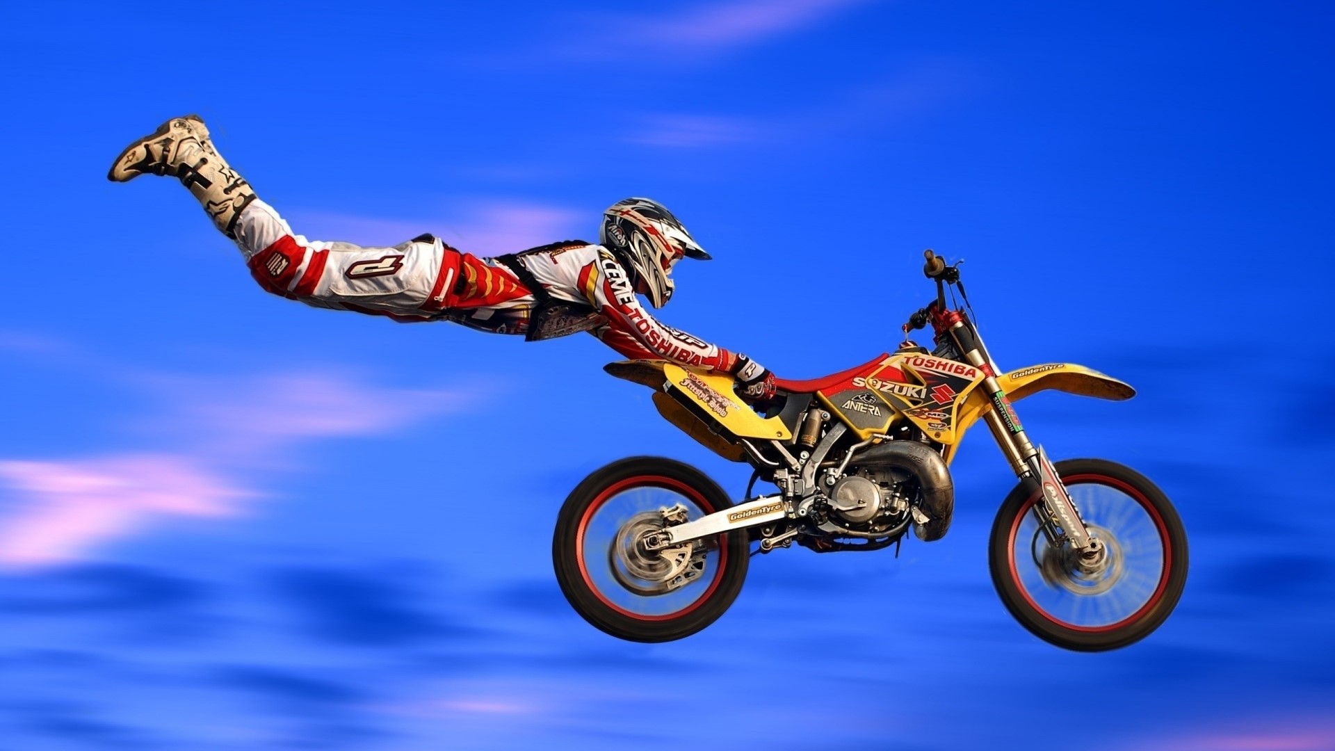 Motocross rider performing a stunt in the sky HD Wallpaper