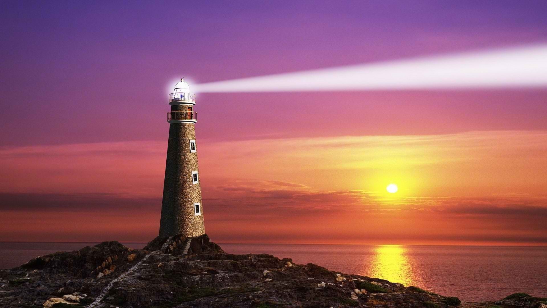 Lighthouse on rocky shore at sunset HD Wallpaper