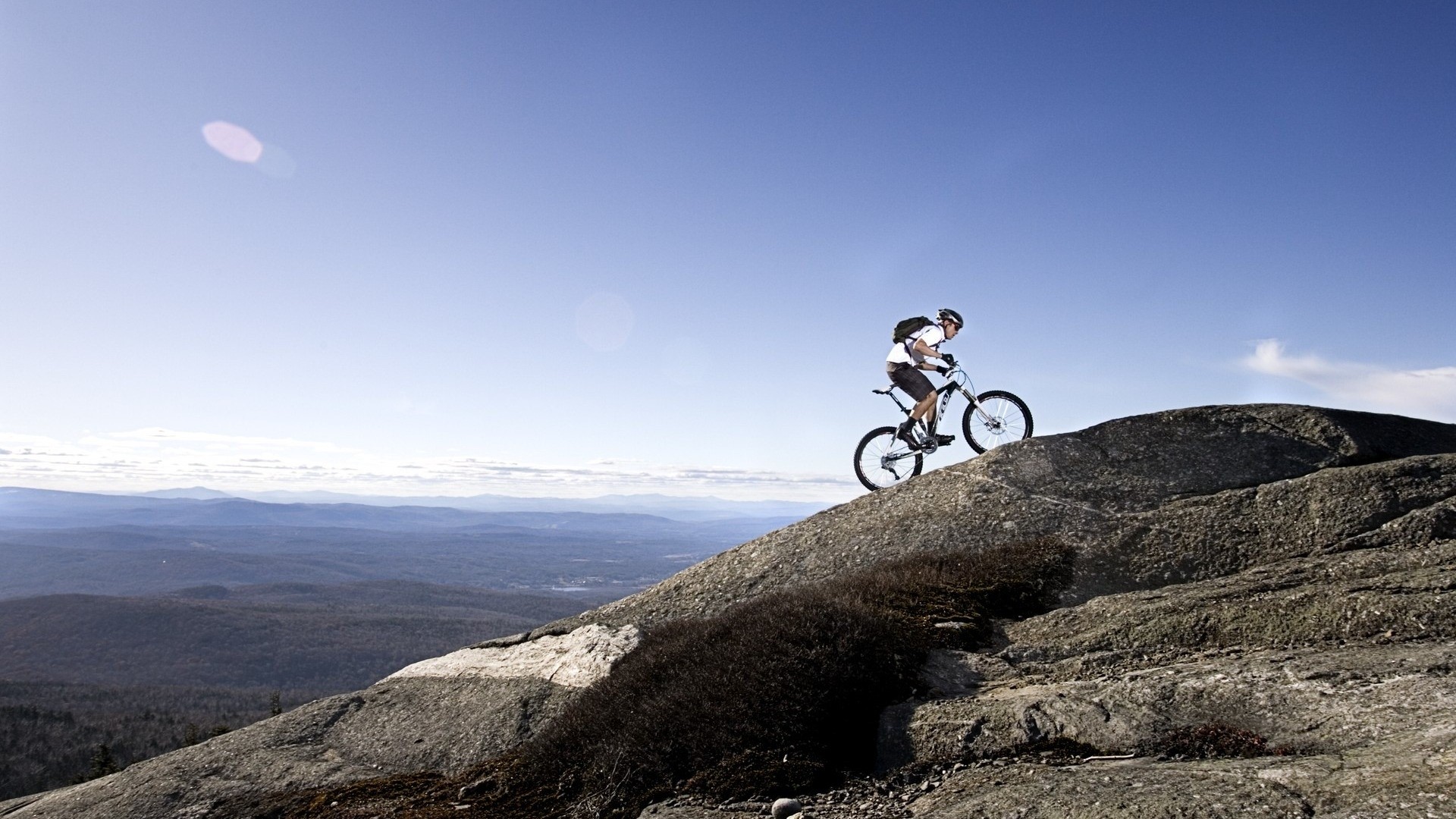Man riding a mountain bike on a rocky hill HD Wallpaper