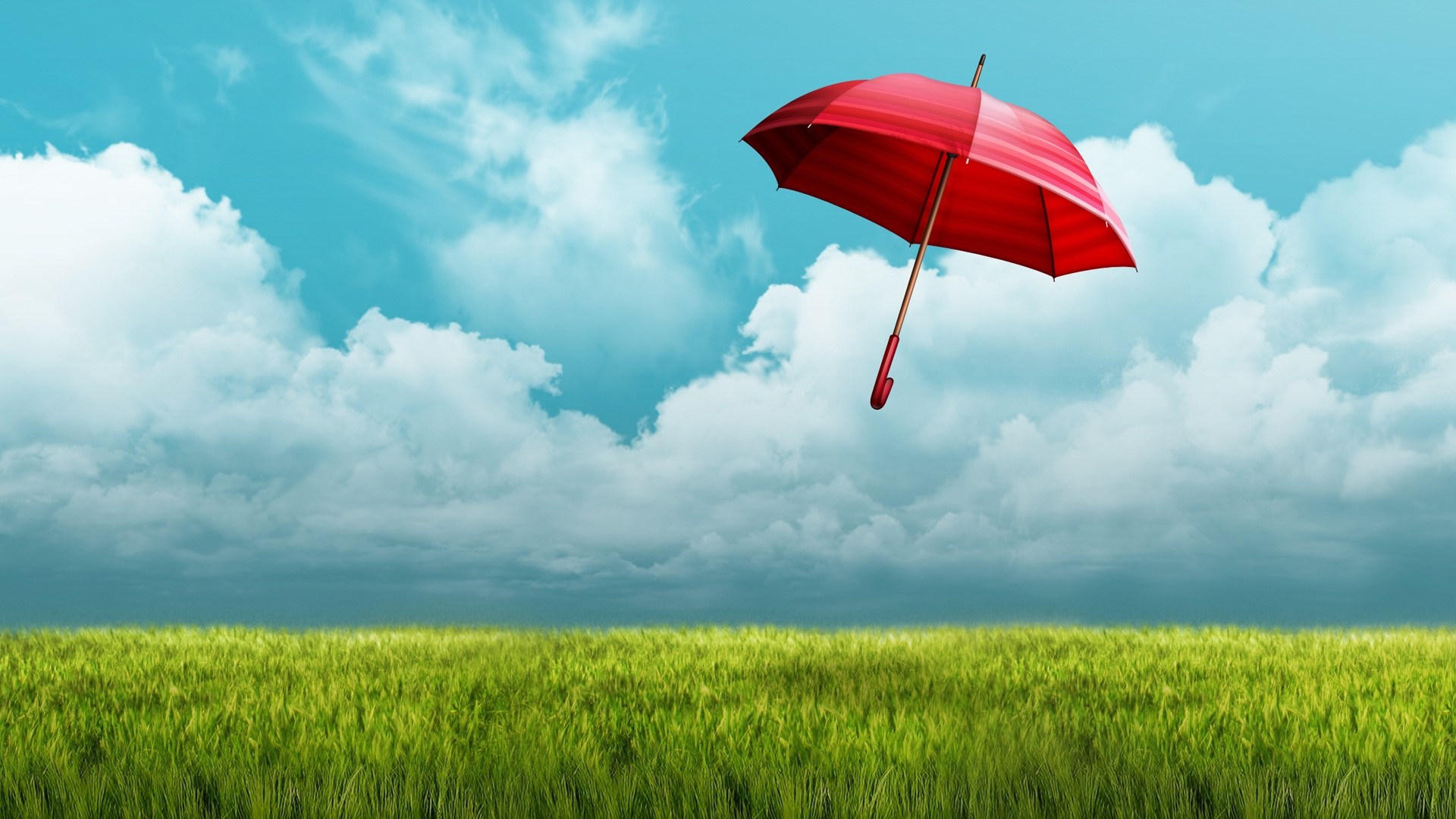 Red umbrella floating over a green field HD Wallpaper