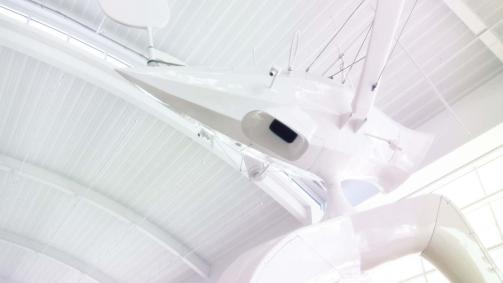 White futuristic aircraft suspended from ceiling HD Wallpaper
