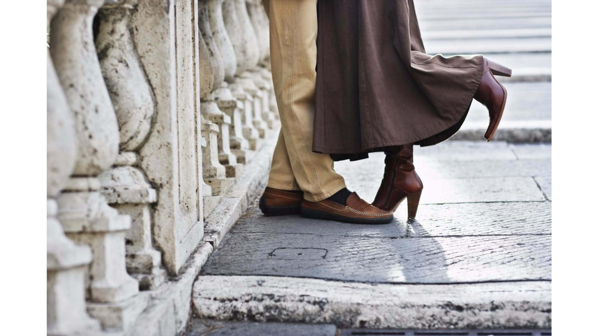 Couple embracing on a stone balcony HD Wallpaper