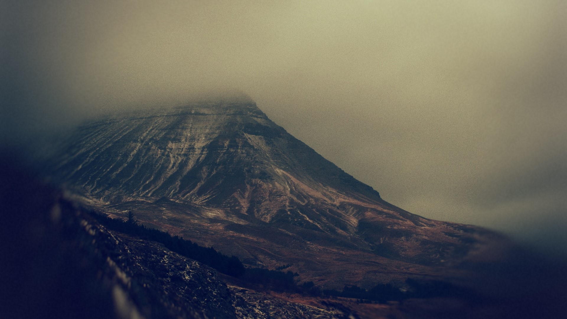 Mountain peak shrouded in fog HD Wallpaper