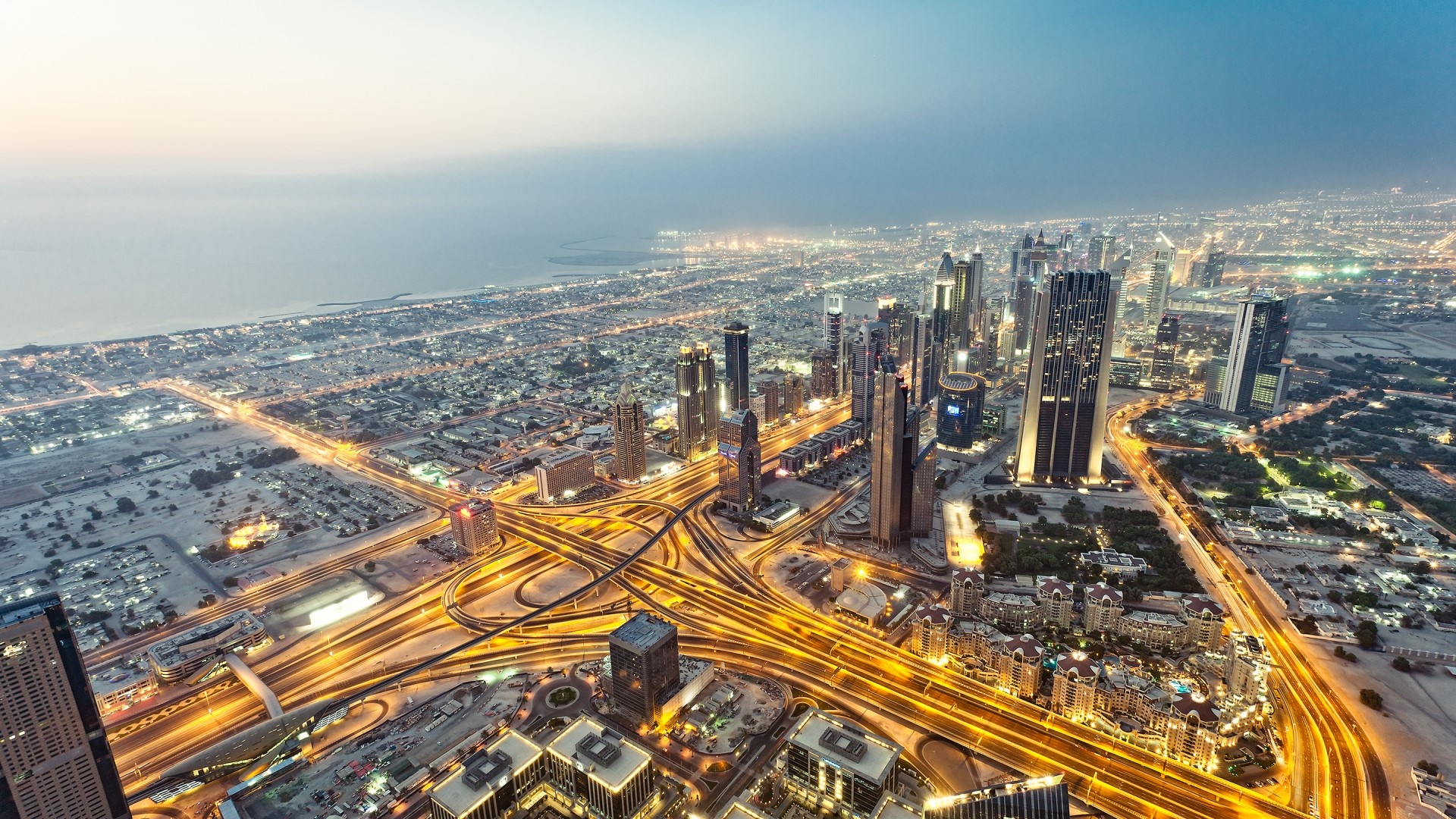 Aerial view of Dubai skyline at dusk HD Wallpaper