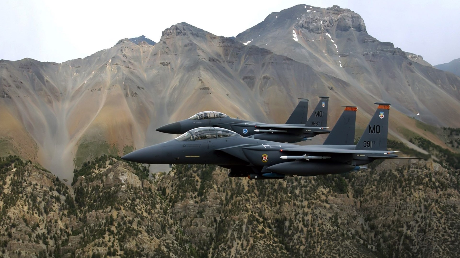 US Air Force F-15 Eagles fly over mountains HD Wallpaper