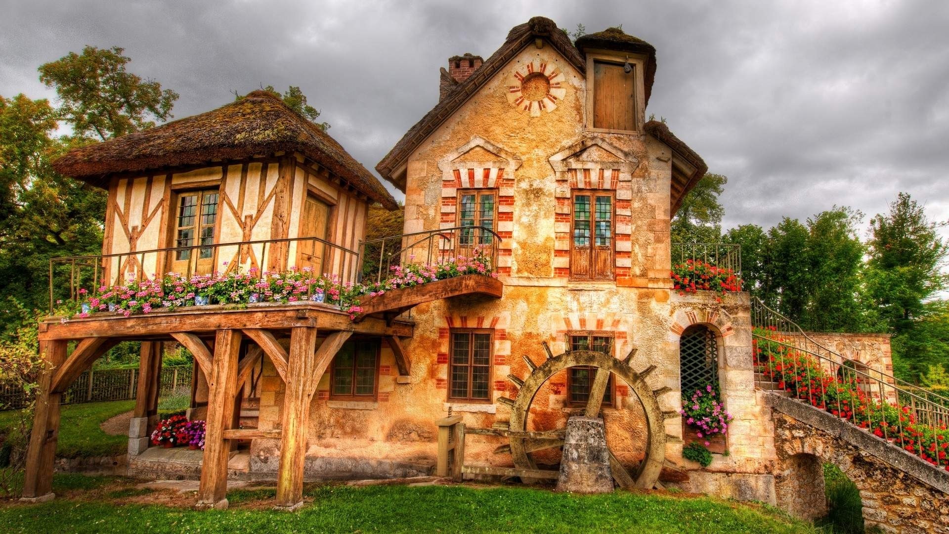 Rustic watermill house with thatched roof and flowers HD Wallpaper