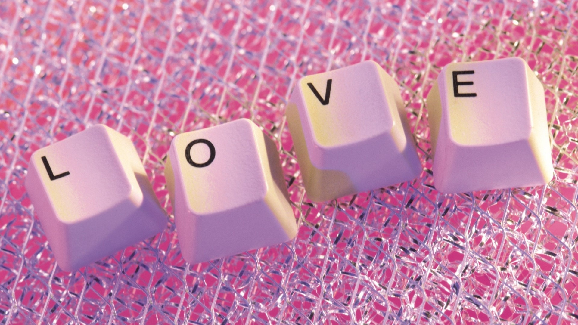 Keyboard keys spelling LOVE on a pink background HD Wallpaper