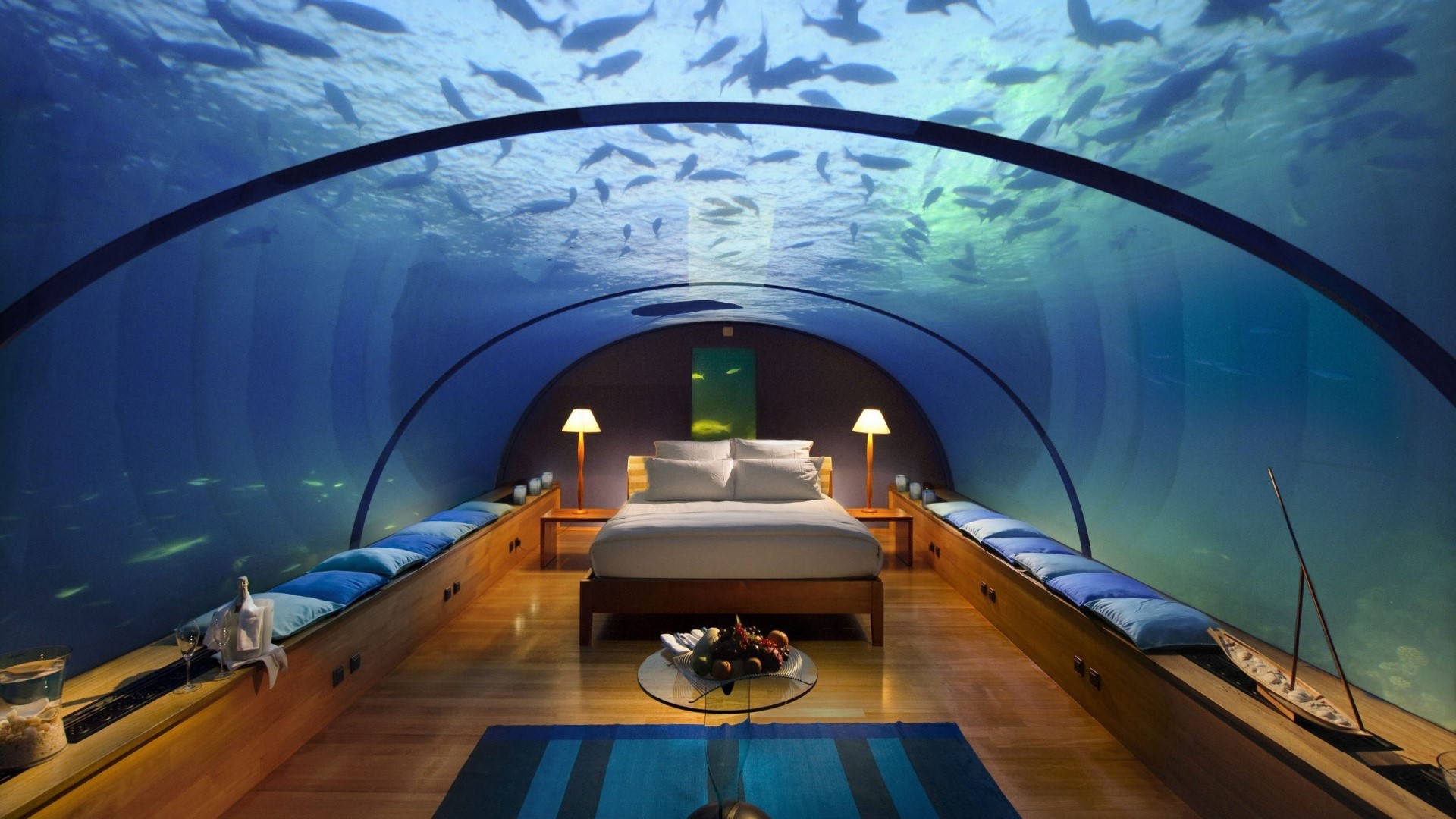 Underwater hotel room with fish swimming above HD Wallpaper